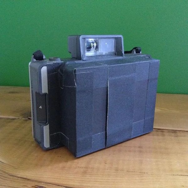 Instant film pinhole camera; completed 2015:  Polaroid Land Camera film back, foam core, gaff tape, stainless steel pinhole