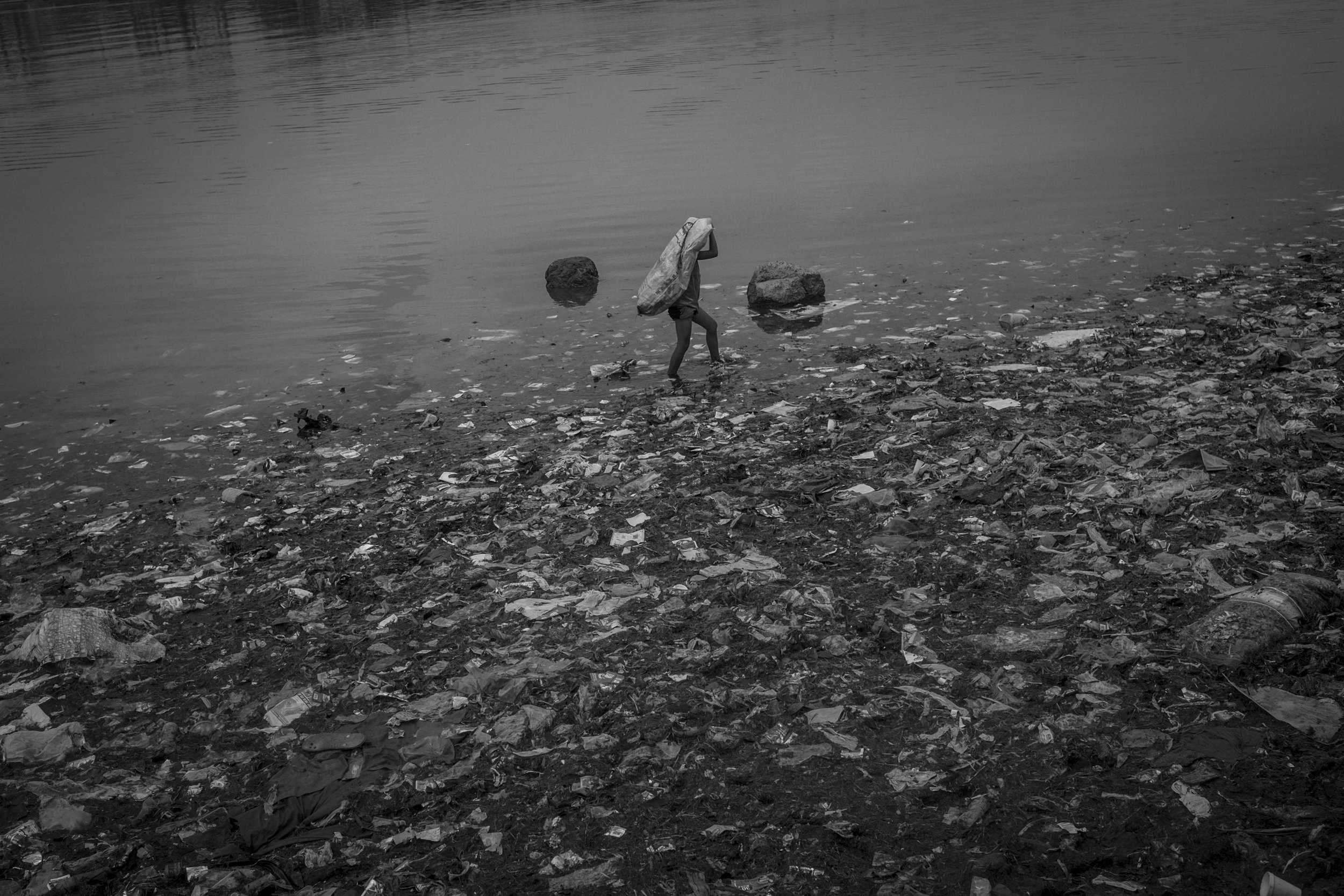  A child collects plastic materials in Baseco compound, in Manila. 