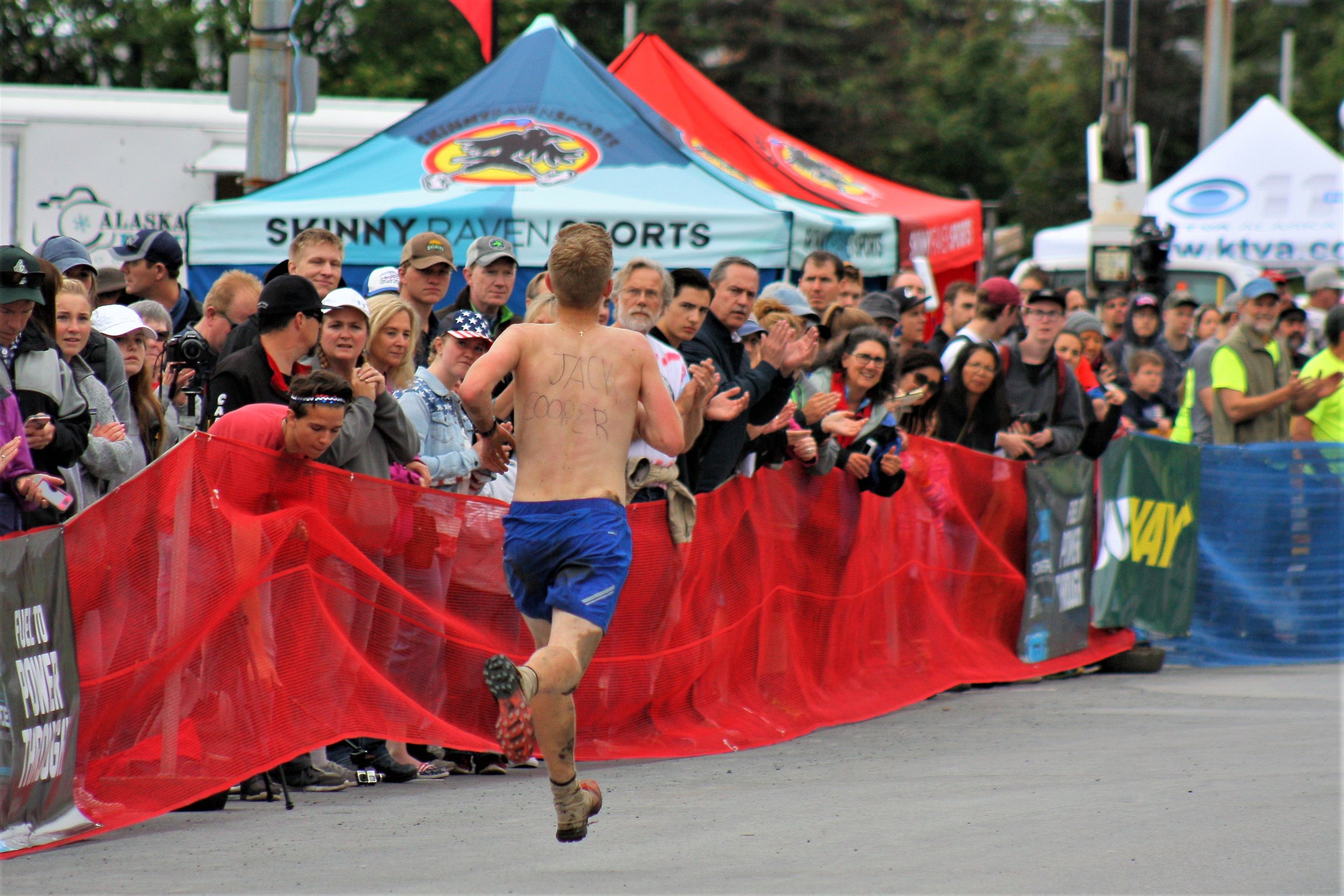 A junior Mount Marathon racer pays homage to Patrick ‘Jack’ Cooper, the 16-year-old runner who was killed by a black bear during the annual race up Bird Ridge last month, by wearing the boy’s name on his back. More than one Mount Marathon racer was seen with the same name written on their body, exemplifying the close-knit community found in Alaska mountain running.