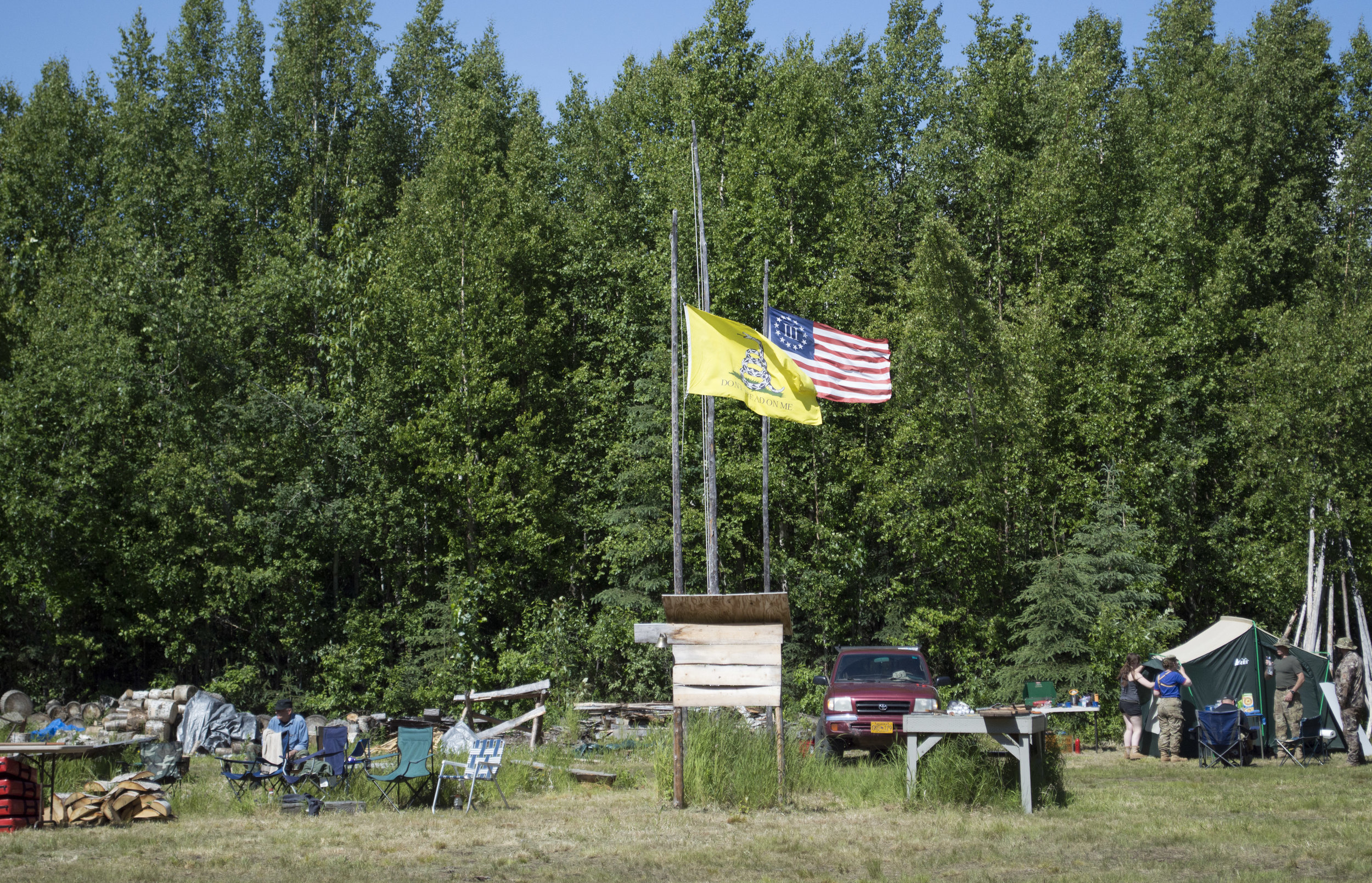 "Don't Tread On Me" and South Central Patriots' flags by the community campfire. 