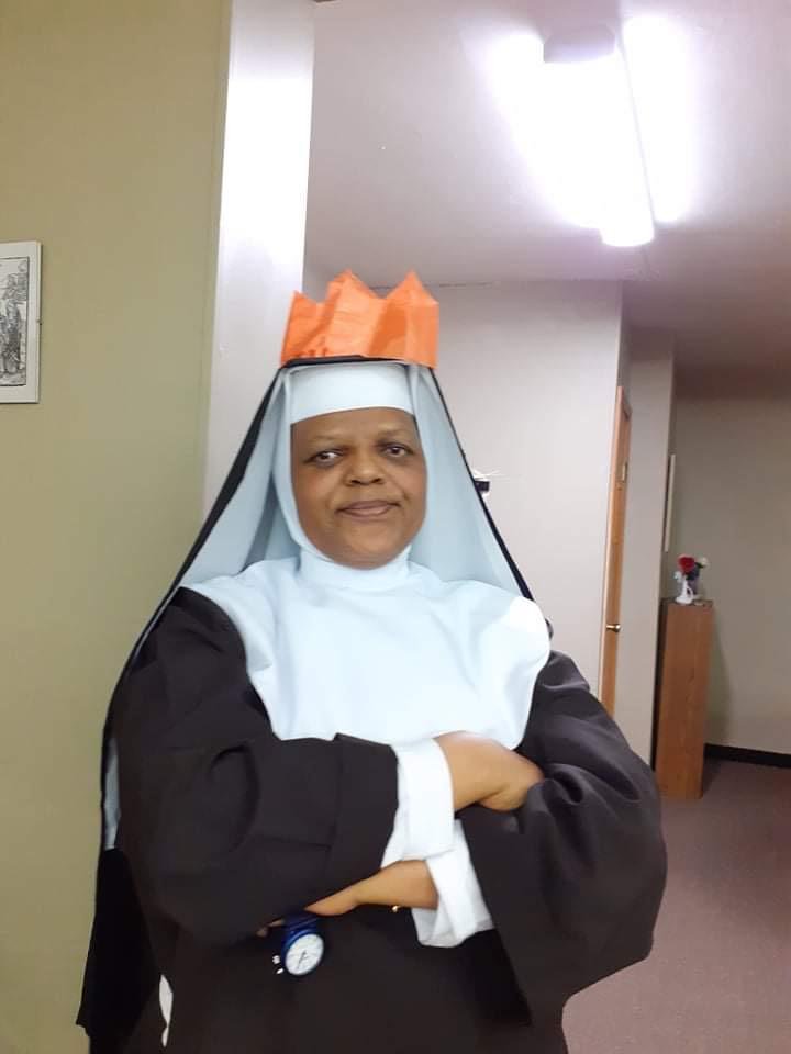 Sr. Mary Agnes is NOT HAVING FUN with our crowns on Christmas. She reminds me of a bouncer.