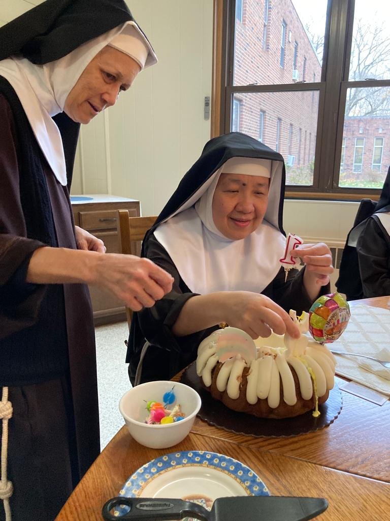 Sr. Mary Magdalen and Mother Mary Gertrude dismantling the candles from her birthday cake so we can dismantle the cake...yes we celebrate birthdays and feast days and any day