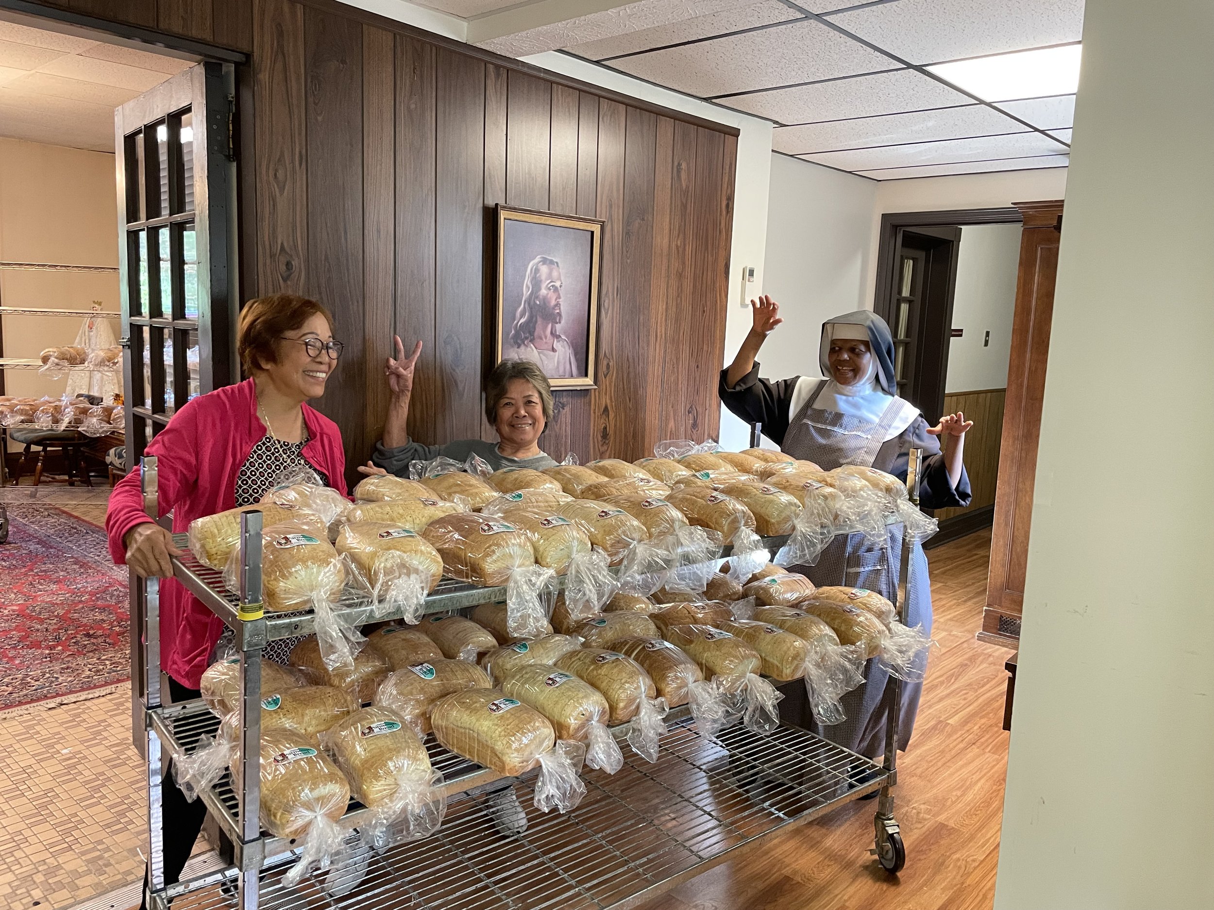  Example # I don’t know of our silliness—Sr. Mary Agnes with a couple of our volunteers. Sr. Mary Agnes runs the bread part of our sale but I am not waking up at 2 AM to get pictures of them actually making the bread.  