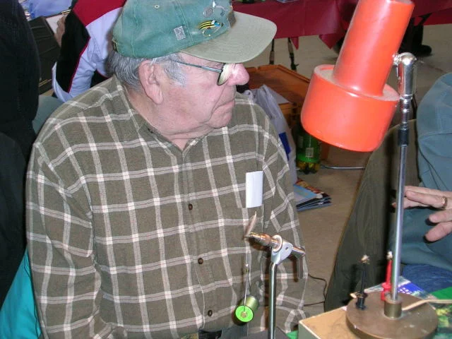 The king of fly tying, and painter's muse, Dick Hepper, showing off his vice prowess. The guy has mad skill.