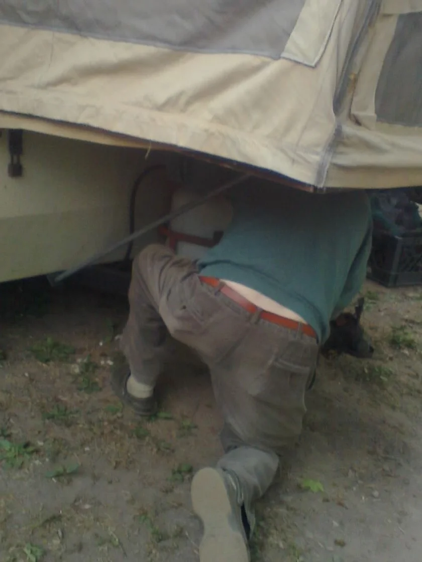 Dick's not afraid of getting dirty when there's work to be done. Here he is hooking up his propane tank.