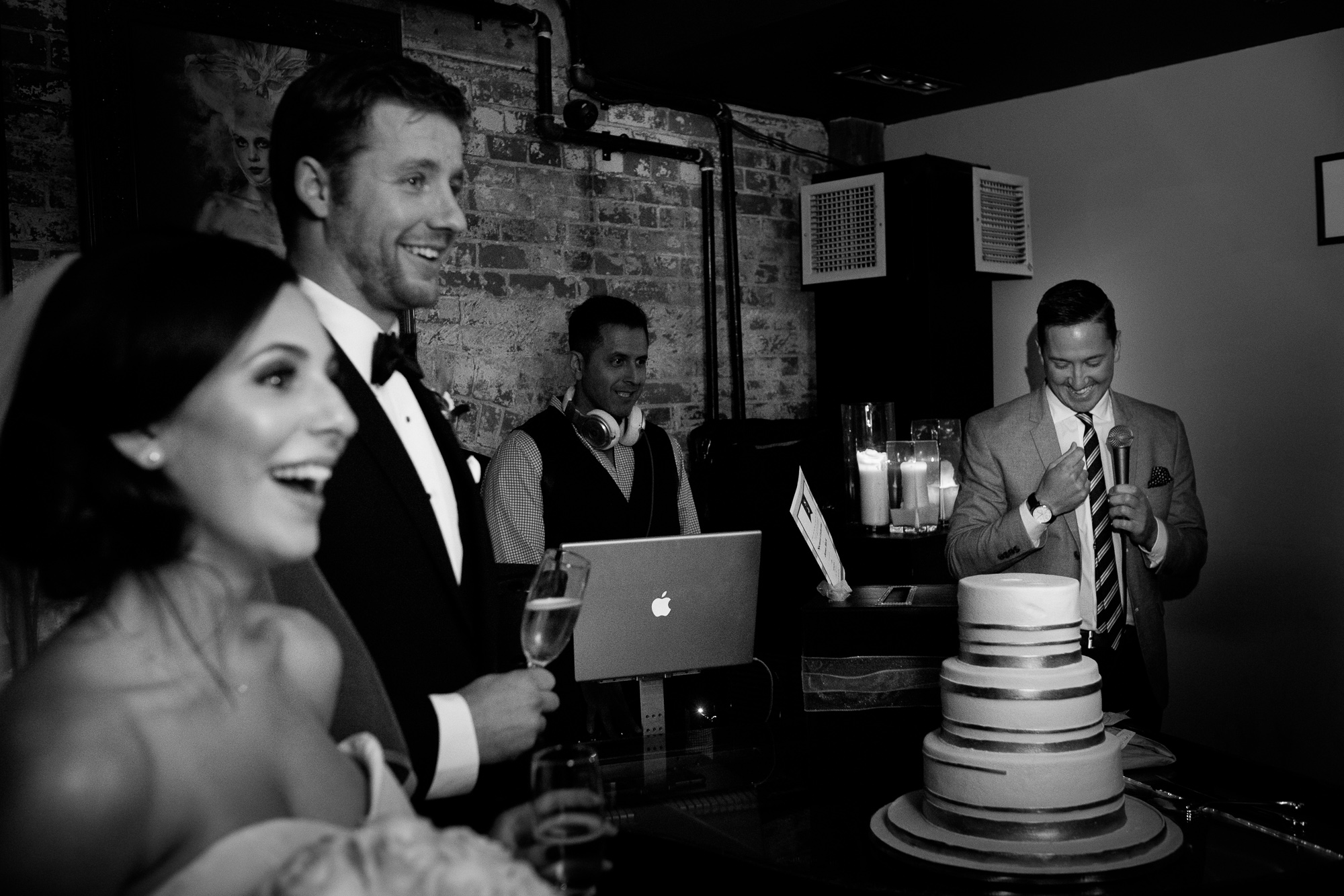Spencer and Jonas enjoy a laugh as their MC begins the festivities during their reception at the Stirling Room in Toronto's Distillery District.