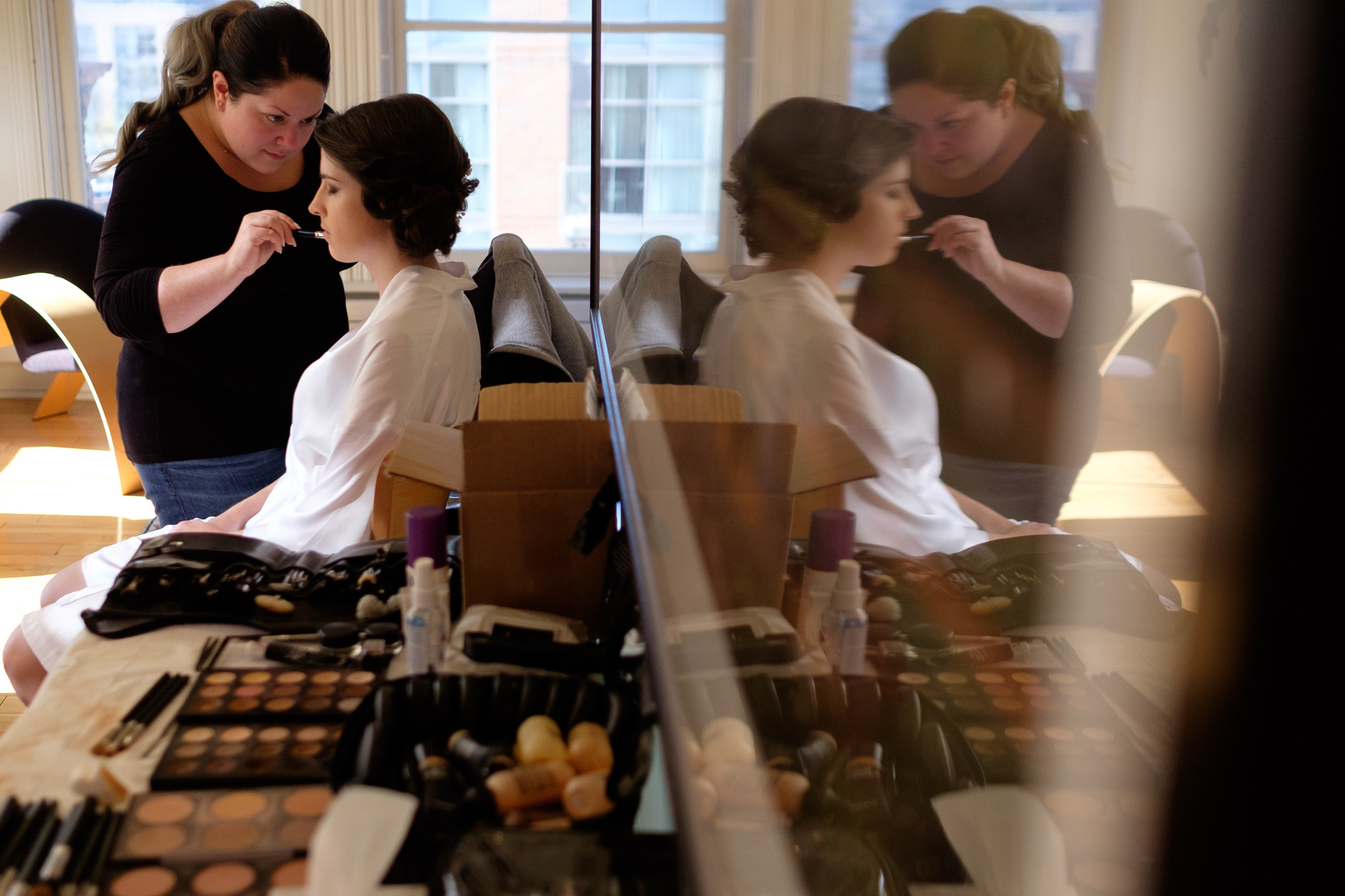  Emilie relaxes while her makeup is done in the penthouse suite at the Gladstone Hotel before her autumn wedding at 99 Sudbury. 