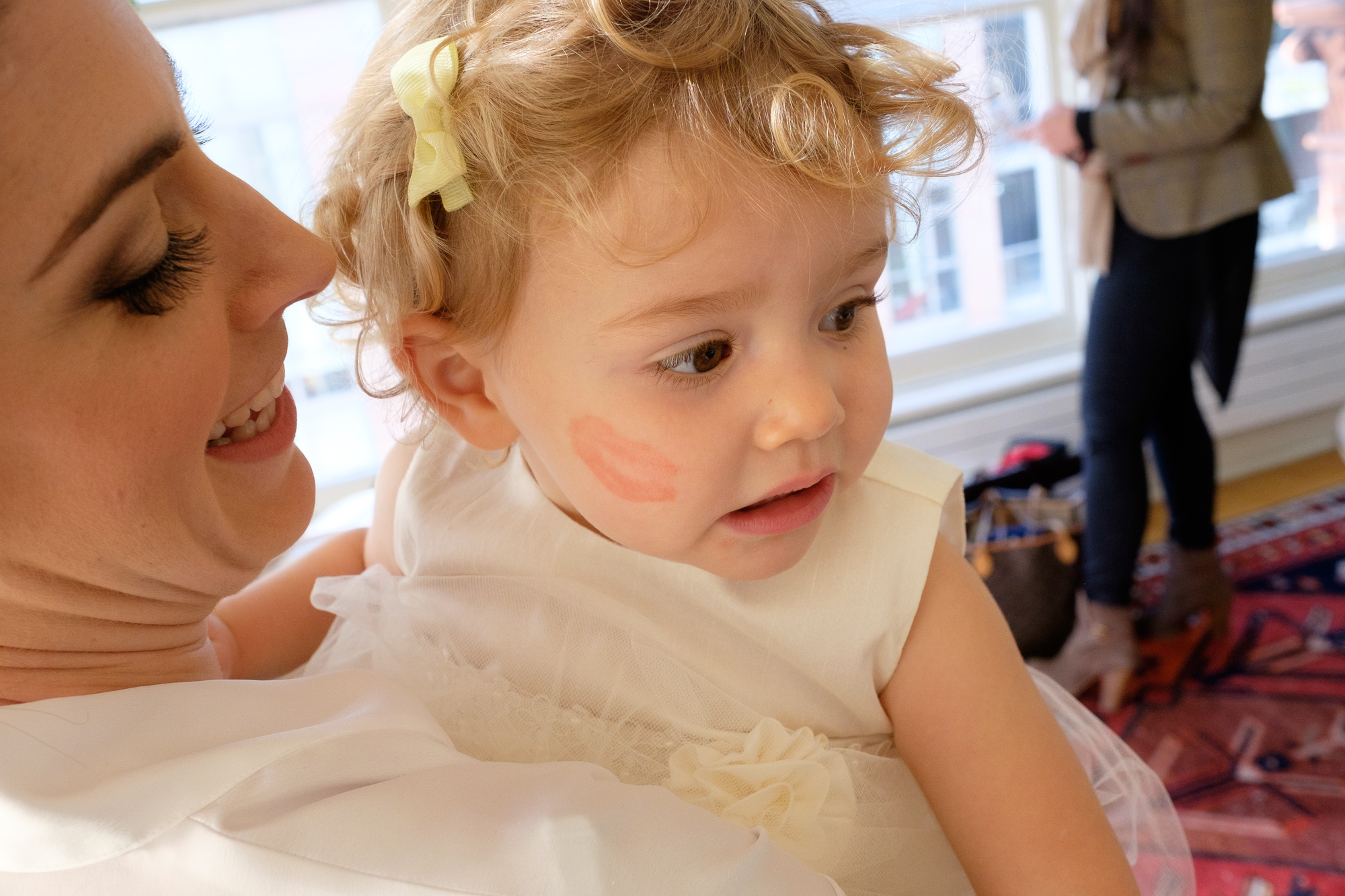  The bride leaves a lipstick kiss on the cheek of her adorable flower girl while getting ready at the Gladstone Hotel. 
