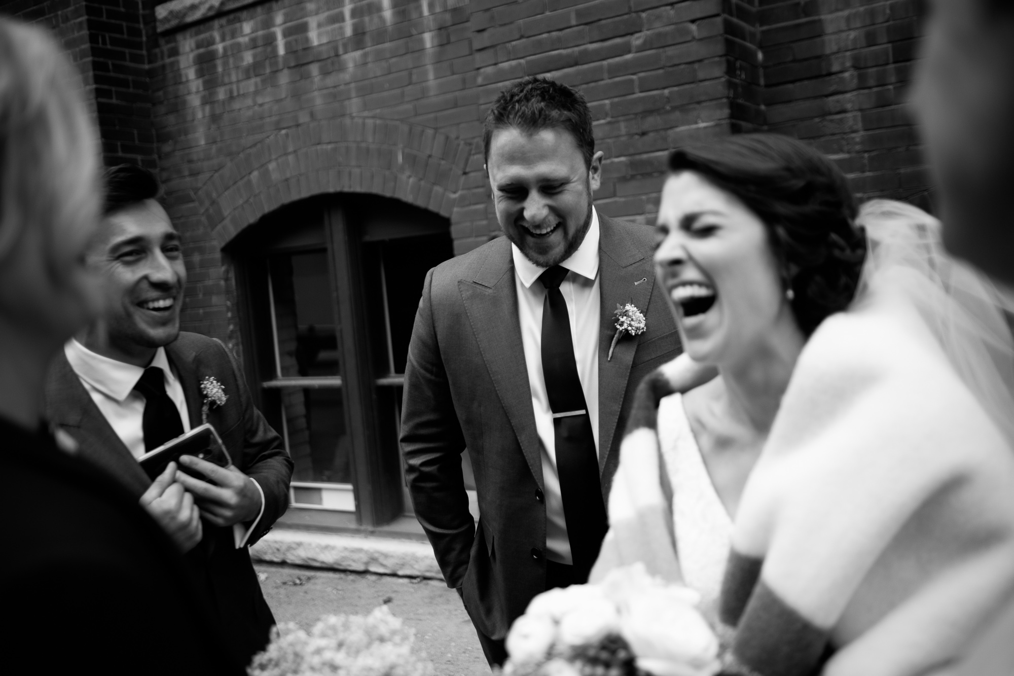  The bridal party enjoys a laugh while we photograph the wedding party portraits in Toronto's Liberty Village. 