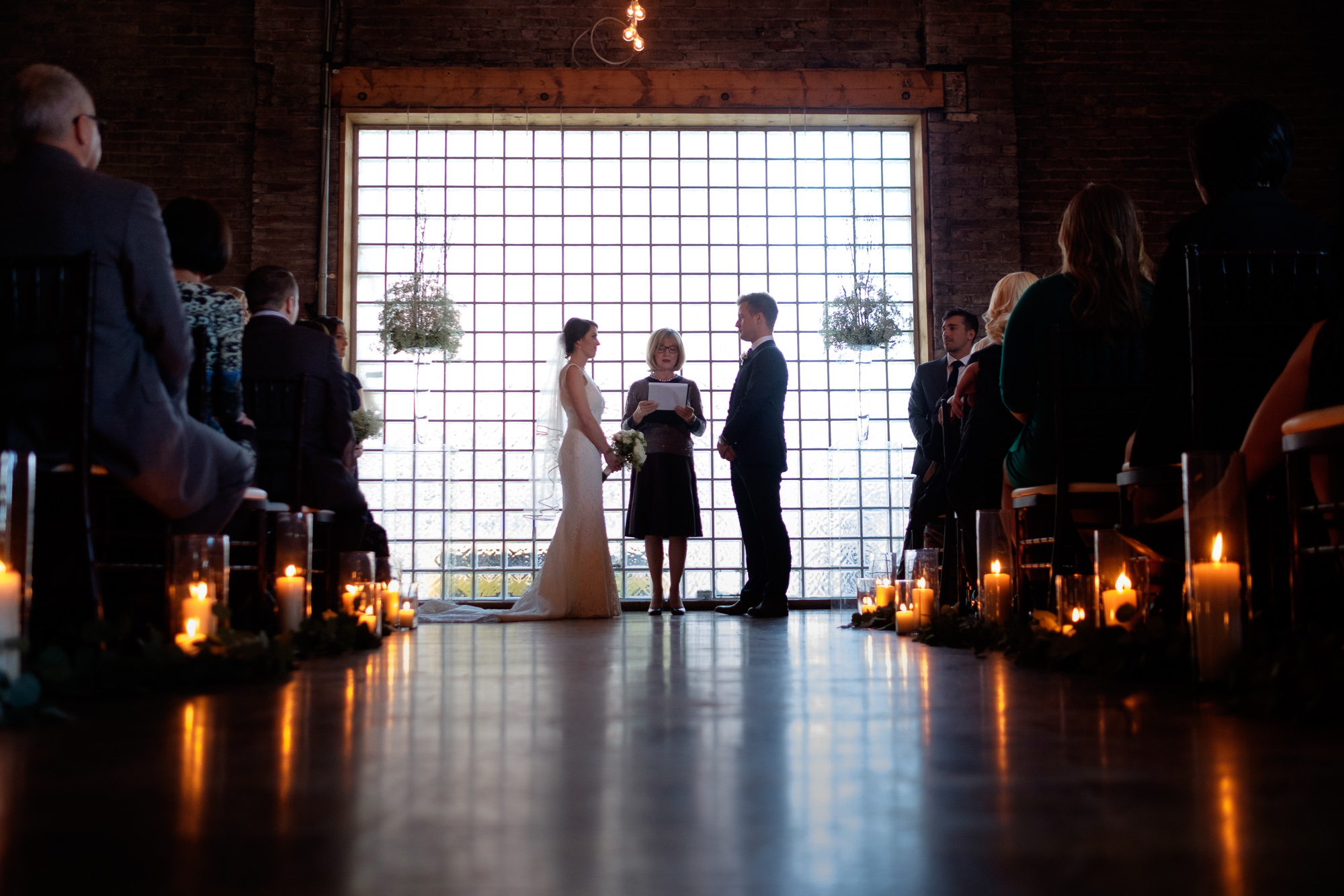 A photograph of the wedding ceremony from Emilie + John's wedding at 99 Sudbury in Toronto. 