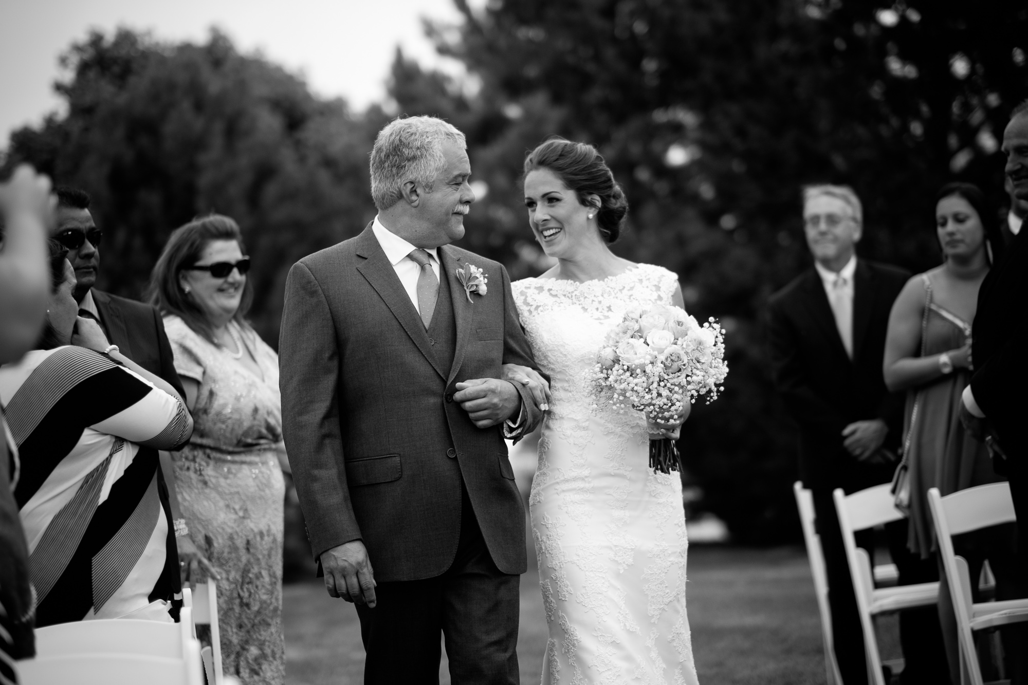  Rebecca and her father share a moment as they walk down the aisle during their outdoor wedding ceremony at the Hessenland Inn. 