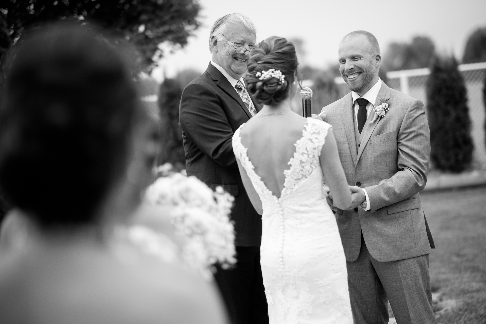 Rebecca + Jeff laugh as they exchange vows during their wedding ceremony at the Hessenland Inn.