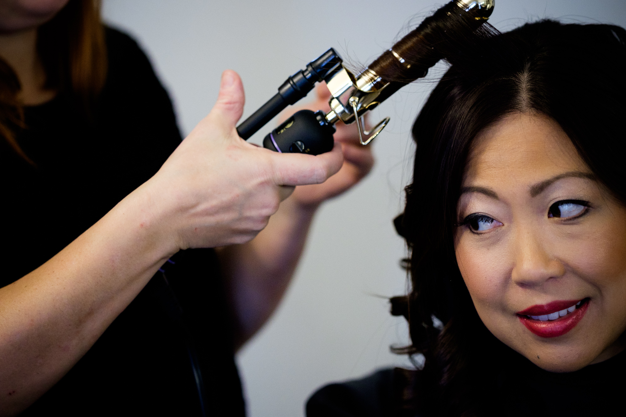 A bridesmaid has her hair done before the wedding.