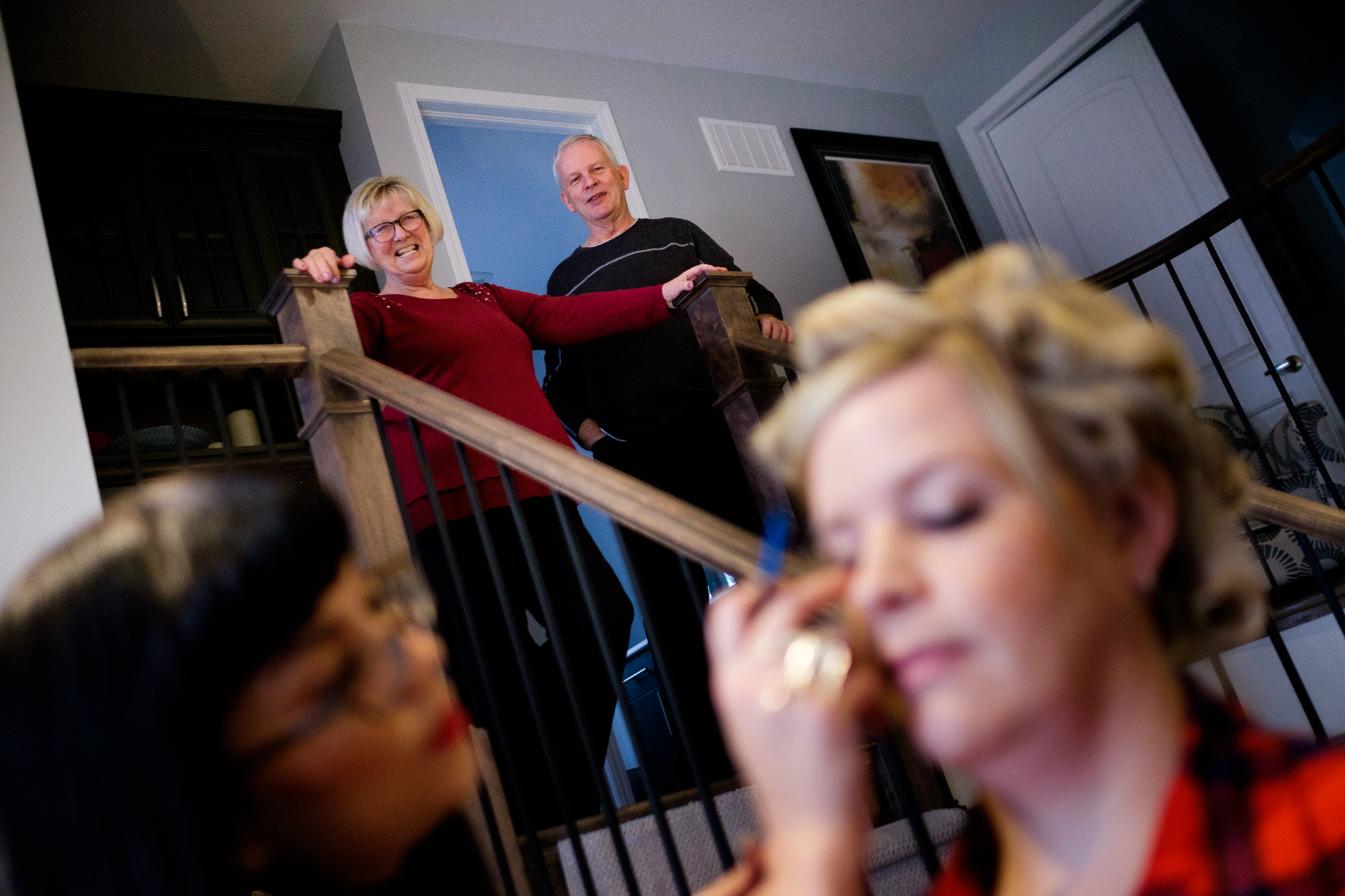 Julia's parents look on as she has her make up done before her wedding at Whistle Bear in Cambridge.
