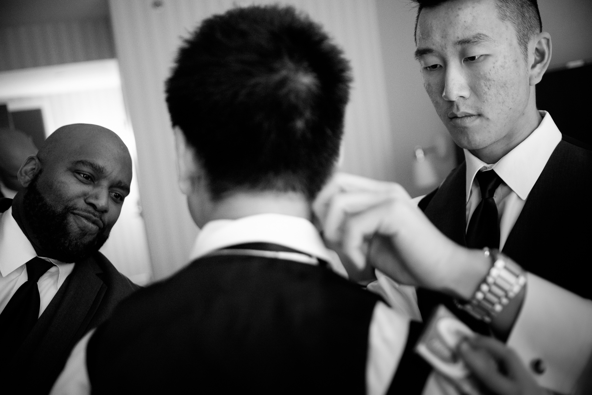 Dan gets help from his groomsmen as he gets ready for his wedding at Whistle Bear.