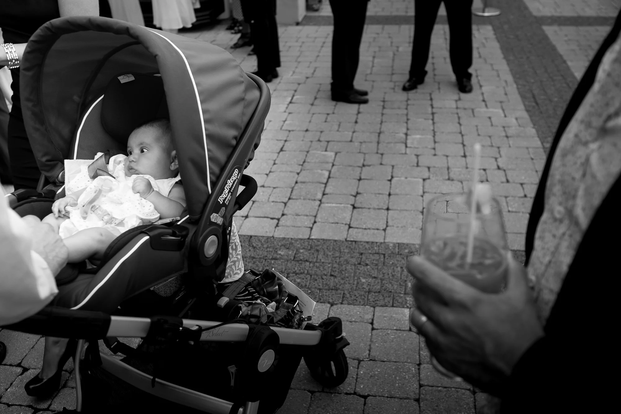 A candid black and white wedding photograph from the cocktail hour of Olivia + David's wedding at Copper Creek just north of Toronto.
