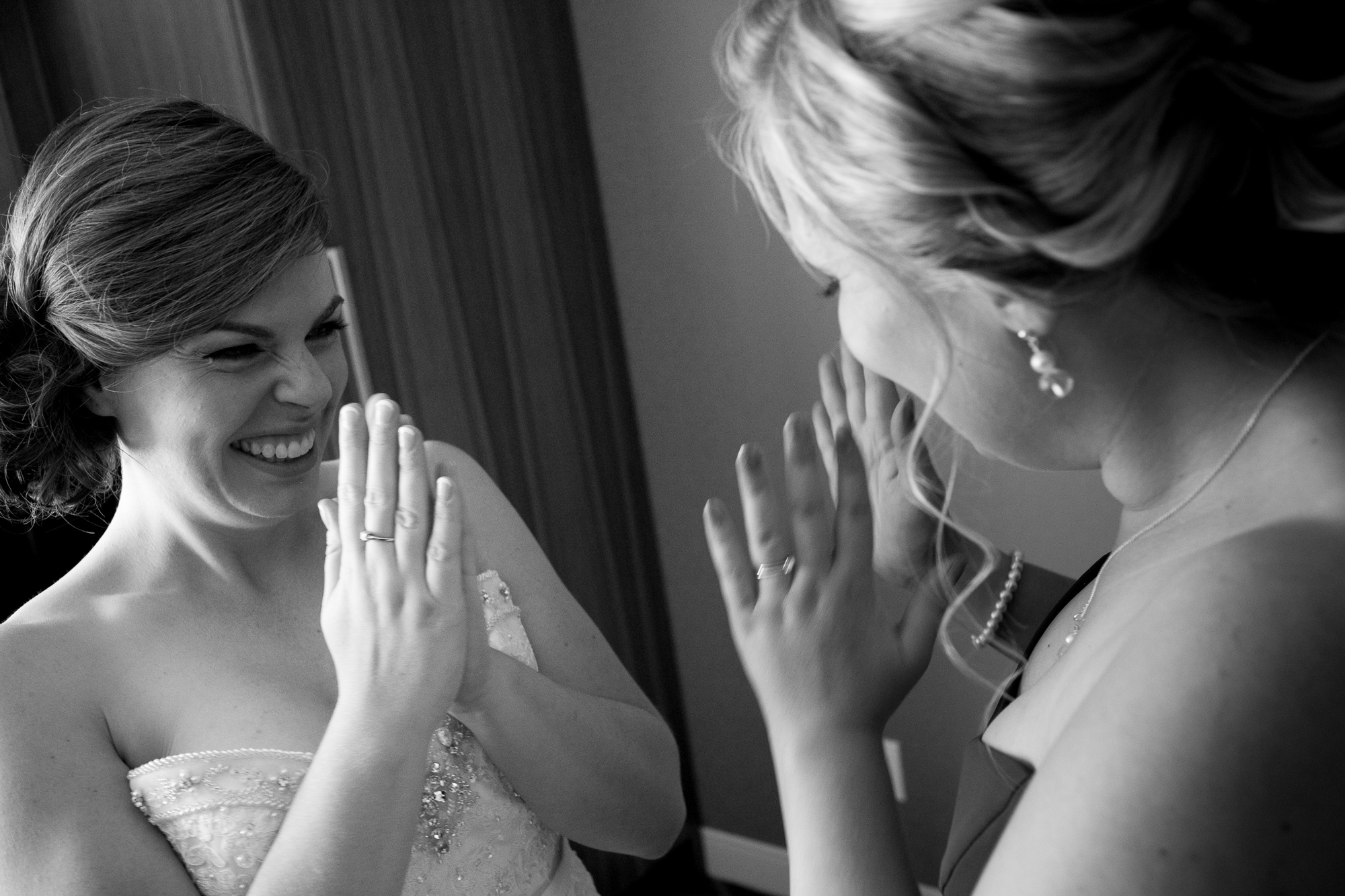  Jennifer and her maid of honour share a moment of excitement once the wedding dress is on and everything starts to feel real before her wedding in Waterloo. 