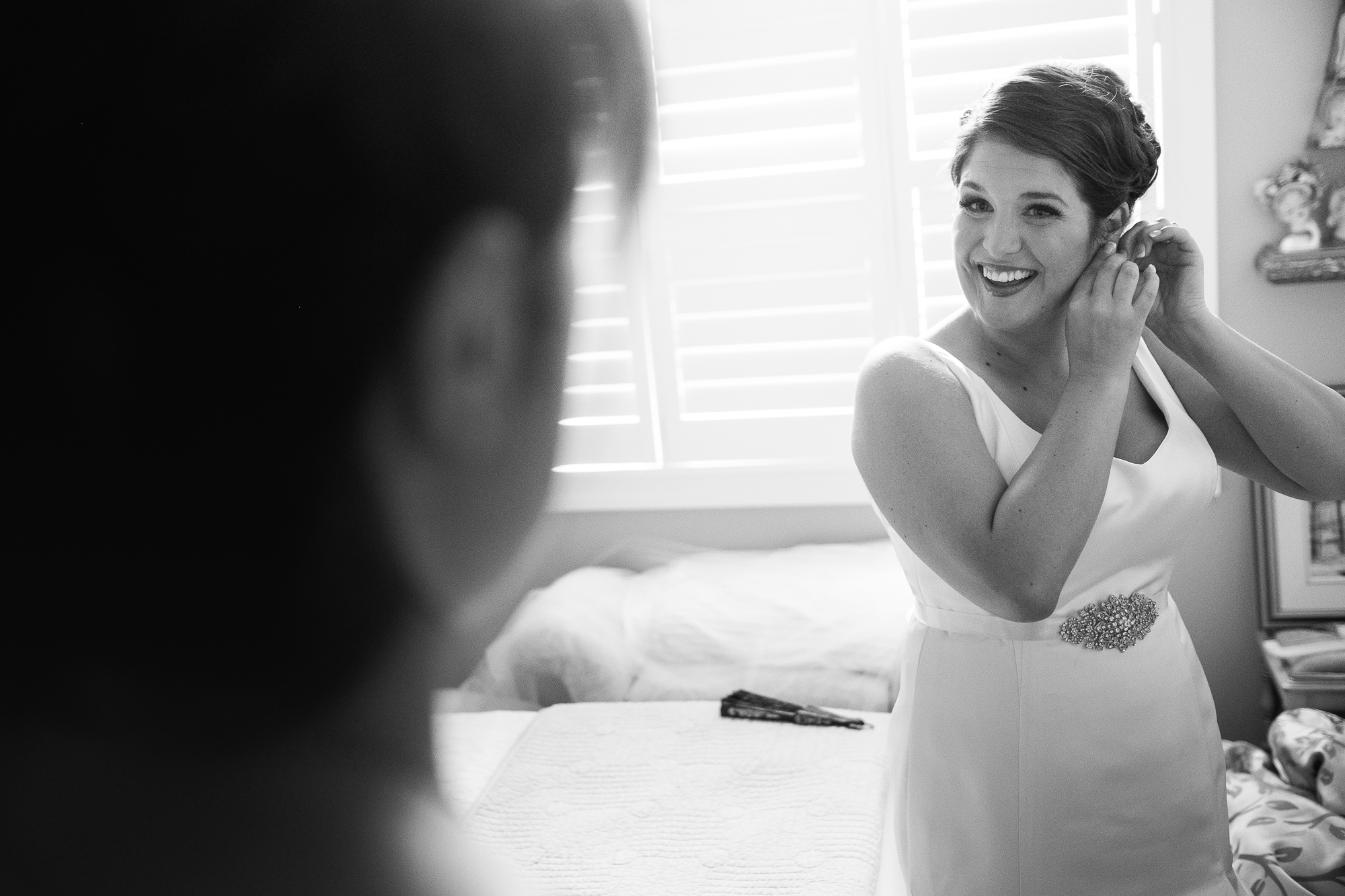 Joanna adjusts her earrings as she gets ready at her parents home in New Hamburg before her wedding ceremony.
