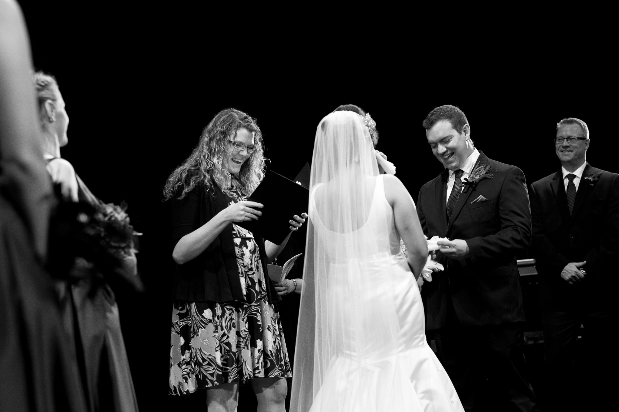  Joanna + Kris' exchange wedding vows up on the stage during their ceremony at the dunfield theatre in Cambridge, Ontario. 