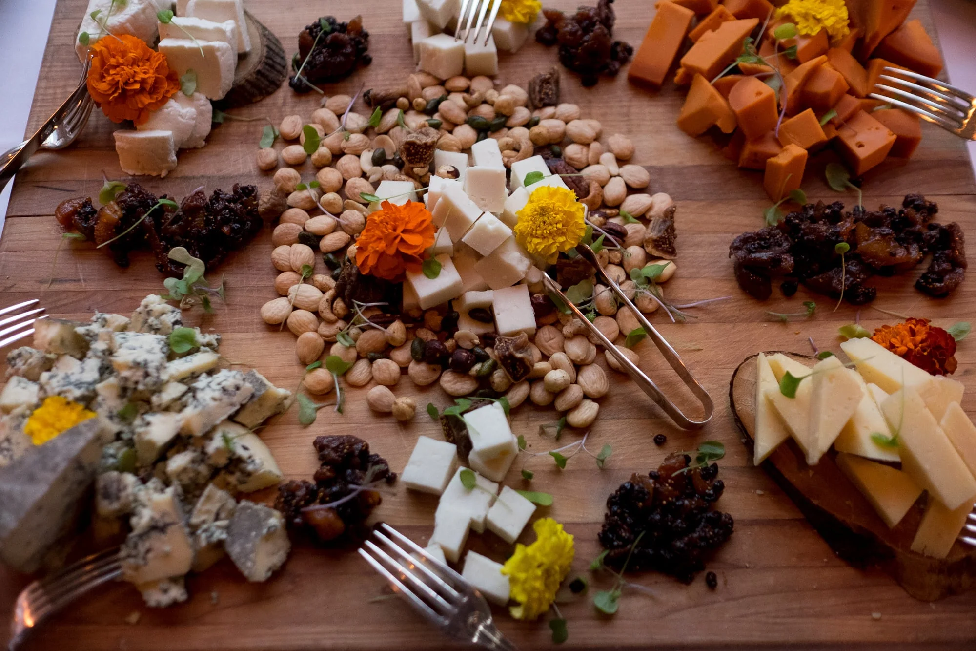 A wedding detail photograph of a delicious charcuterie tray from the cocktail hour of Renee + Senem's Langdon Hall wedding.