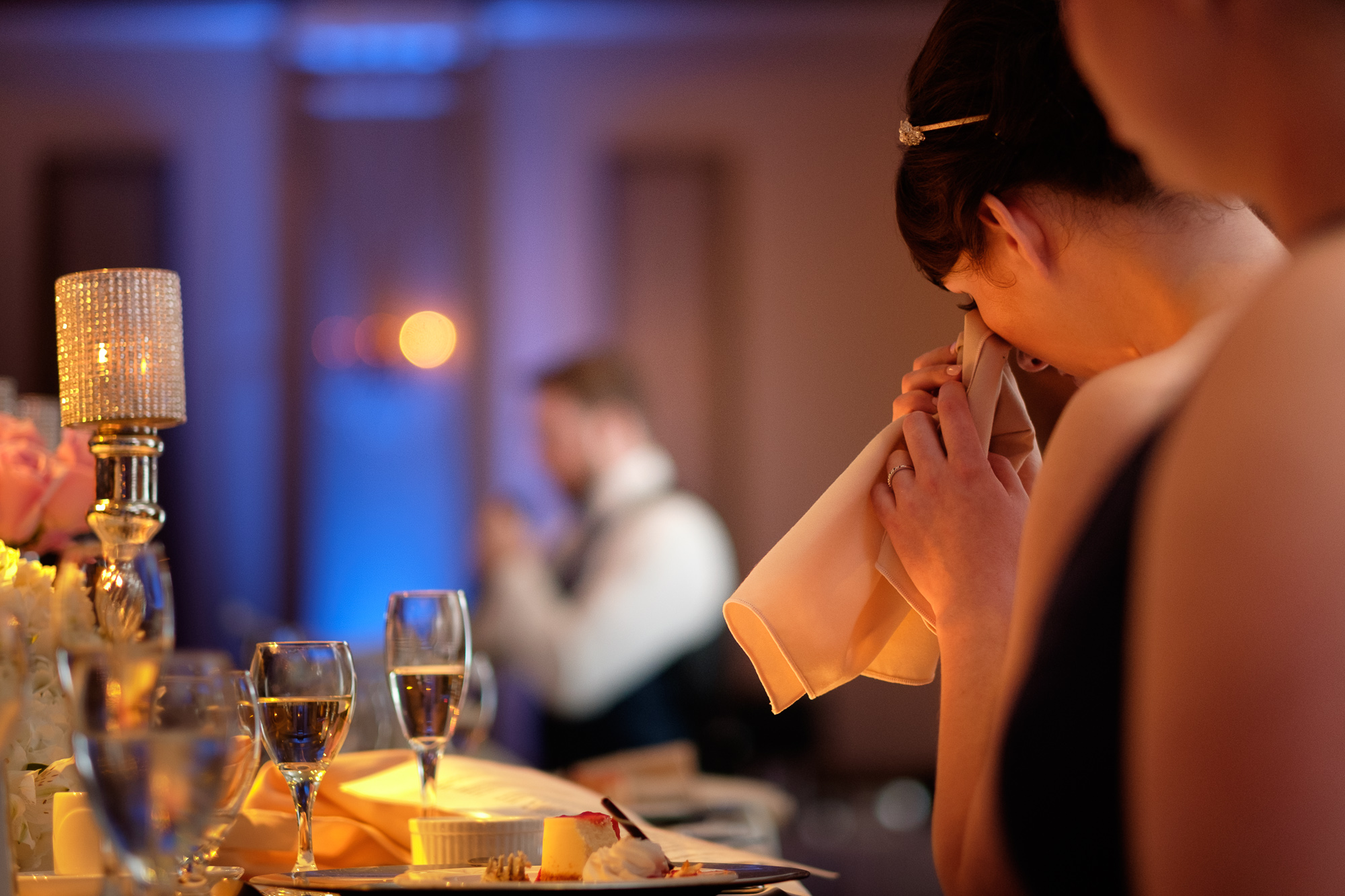 Jennifer wipes a tear away while listening to an emotional speech by the best man at their Toronto Wedding.