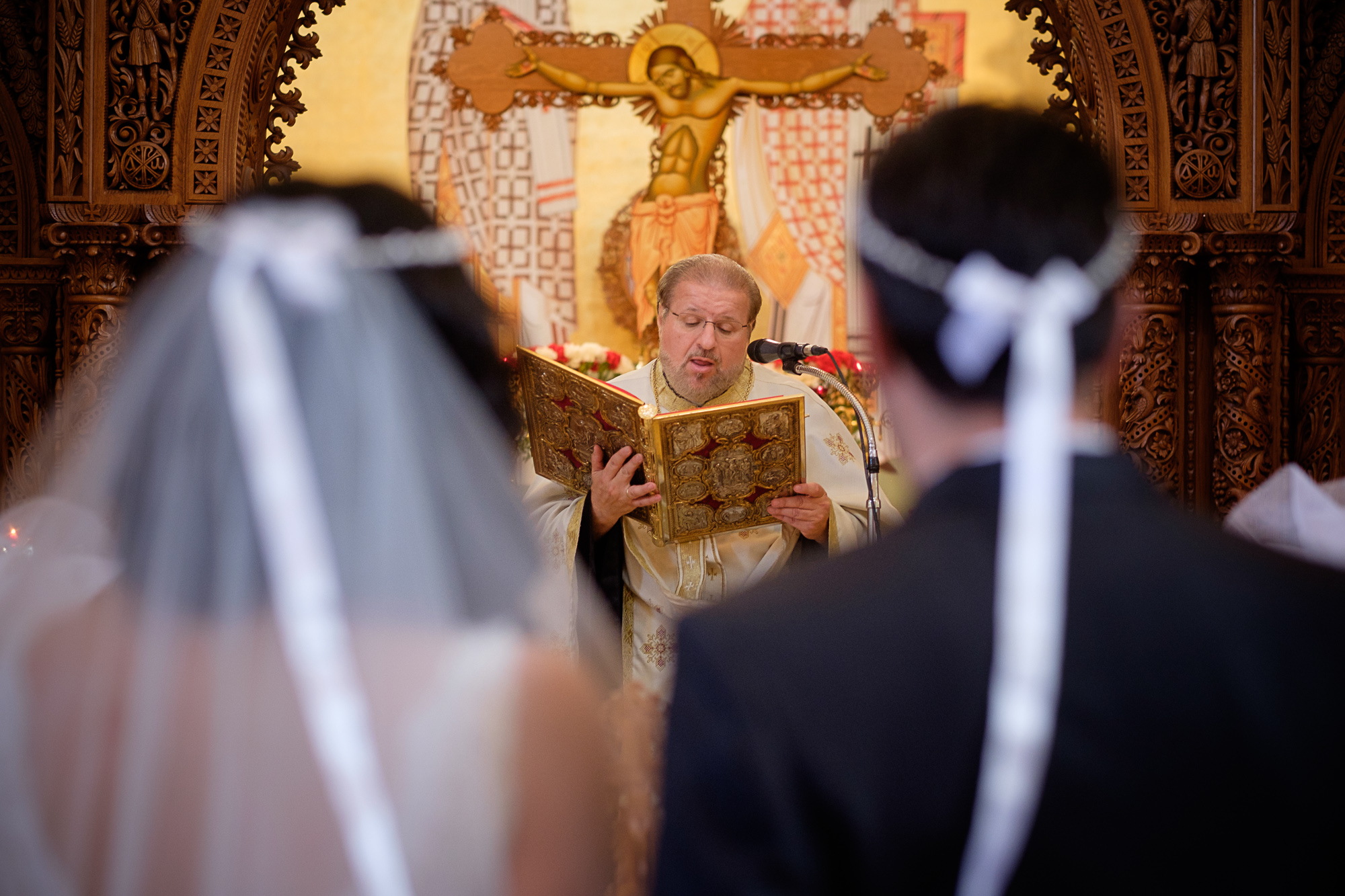  The priest blesses the couple during their wedding ceremony at a Toronto Greek Orthodox Church. 