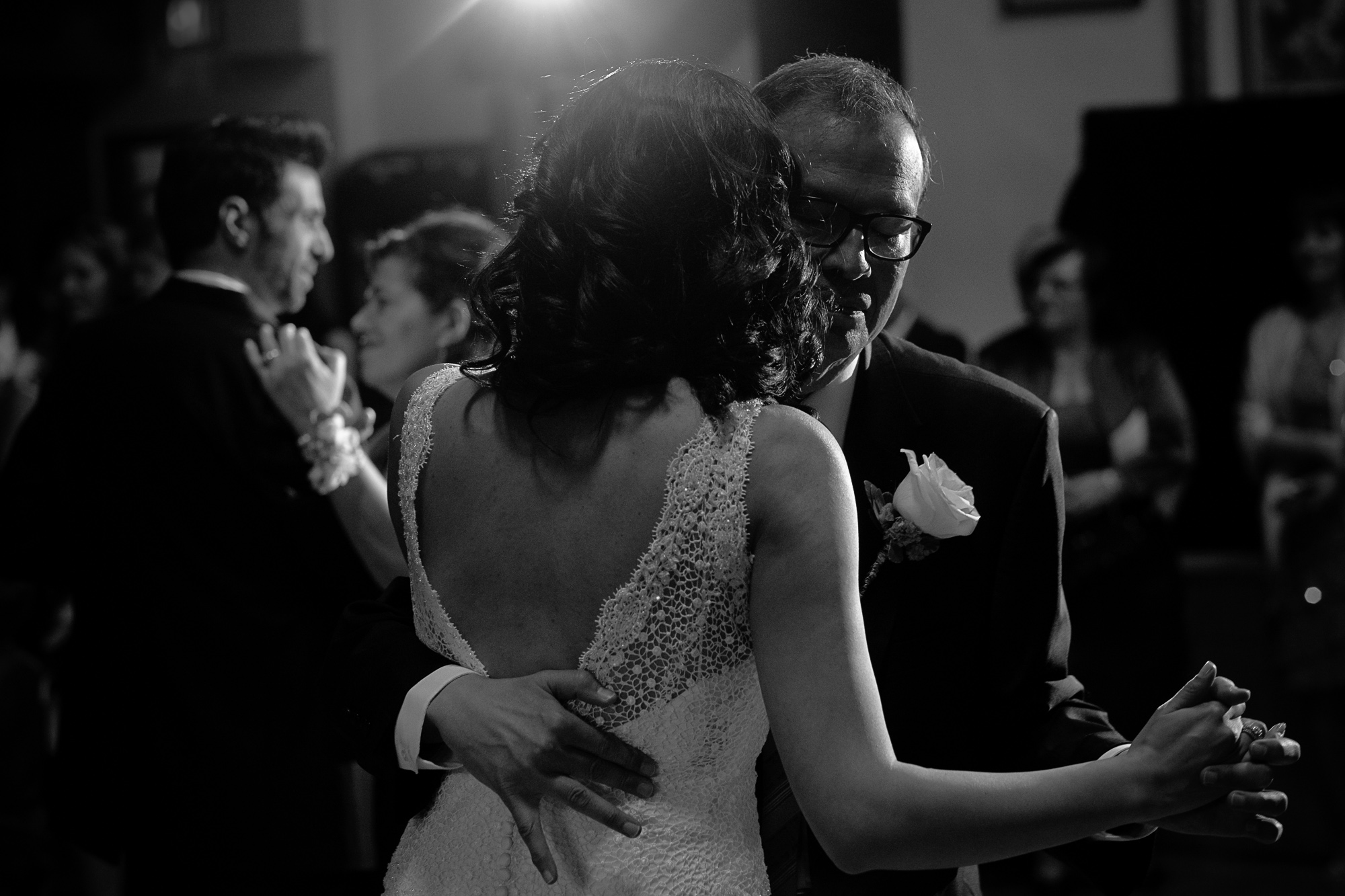  Maria dances with her father during the Toronto wedding reception while Theo dances with his mother in the background. 