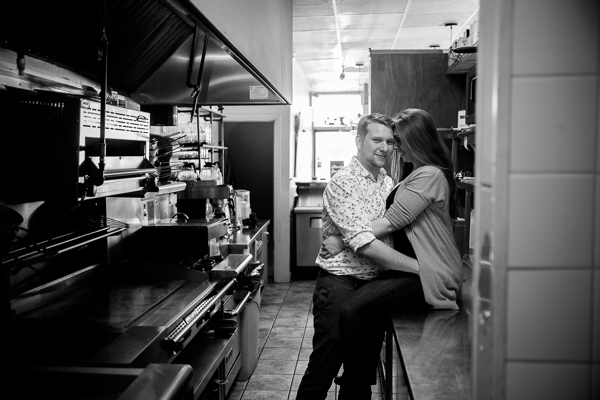  Haley + Stephen pose for a quick engagement portrait inside the kitchen of their Toronto restaurant.&nbsp; 