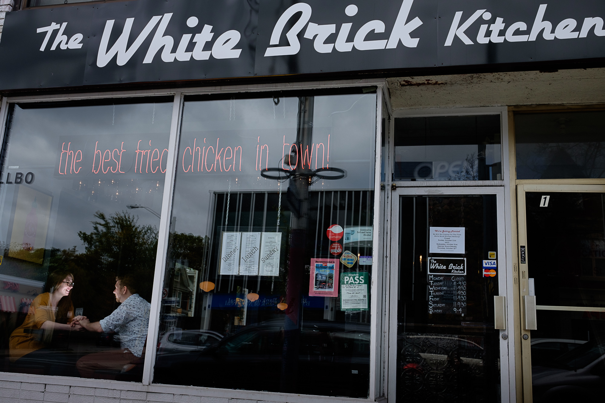 Haley and Stephen in an engagement portrait during their engagement photo shoot in the the restaurant 'White Brick Kitchen' that they own in Downtown Toronto.
