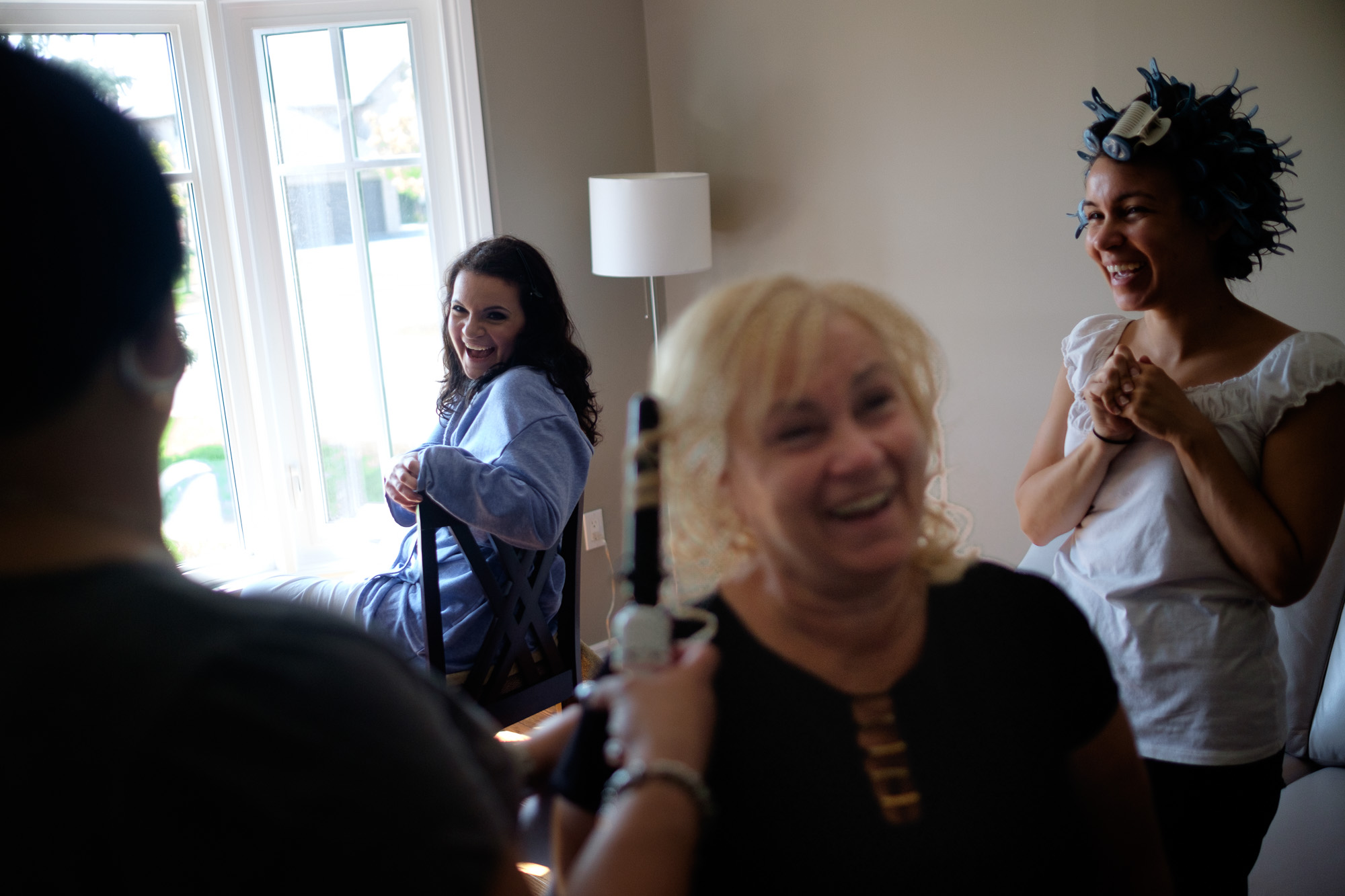  Laura and her family share a laugh as they have their hair and makeup done before her wedding at the Paletta Mansion in Mississauga. 