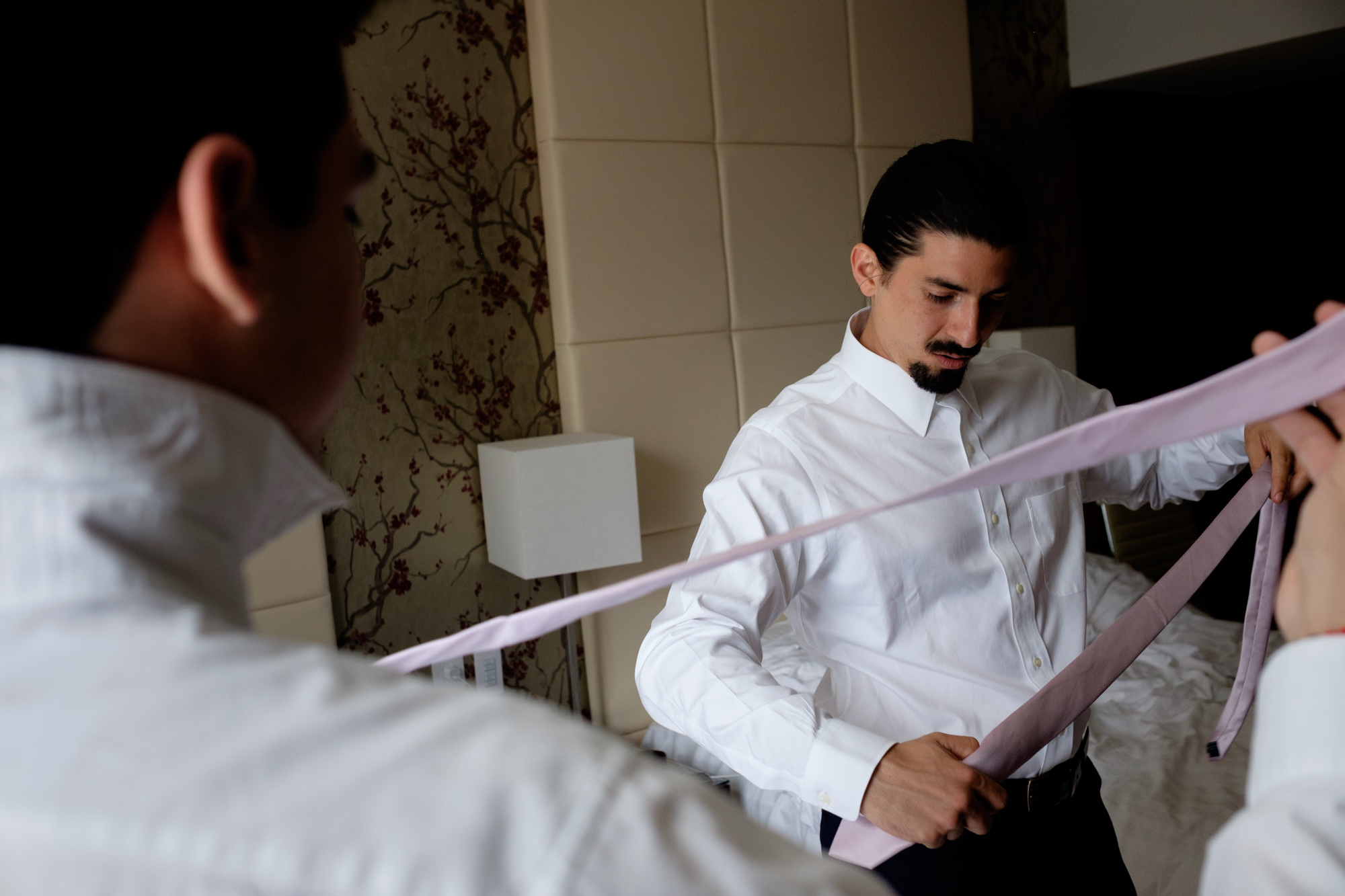  Felipe and his groomsmen get ready and adjust their ties in their suite at the shangri-La Hotel in Toronto before their wedding at the Fermenting Cellar. 