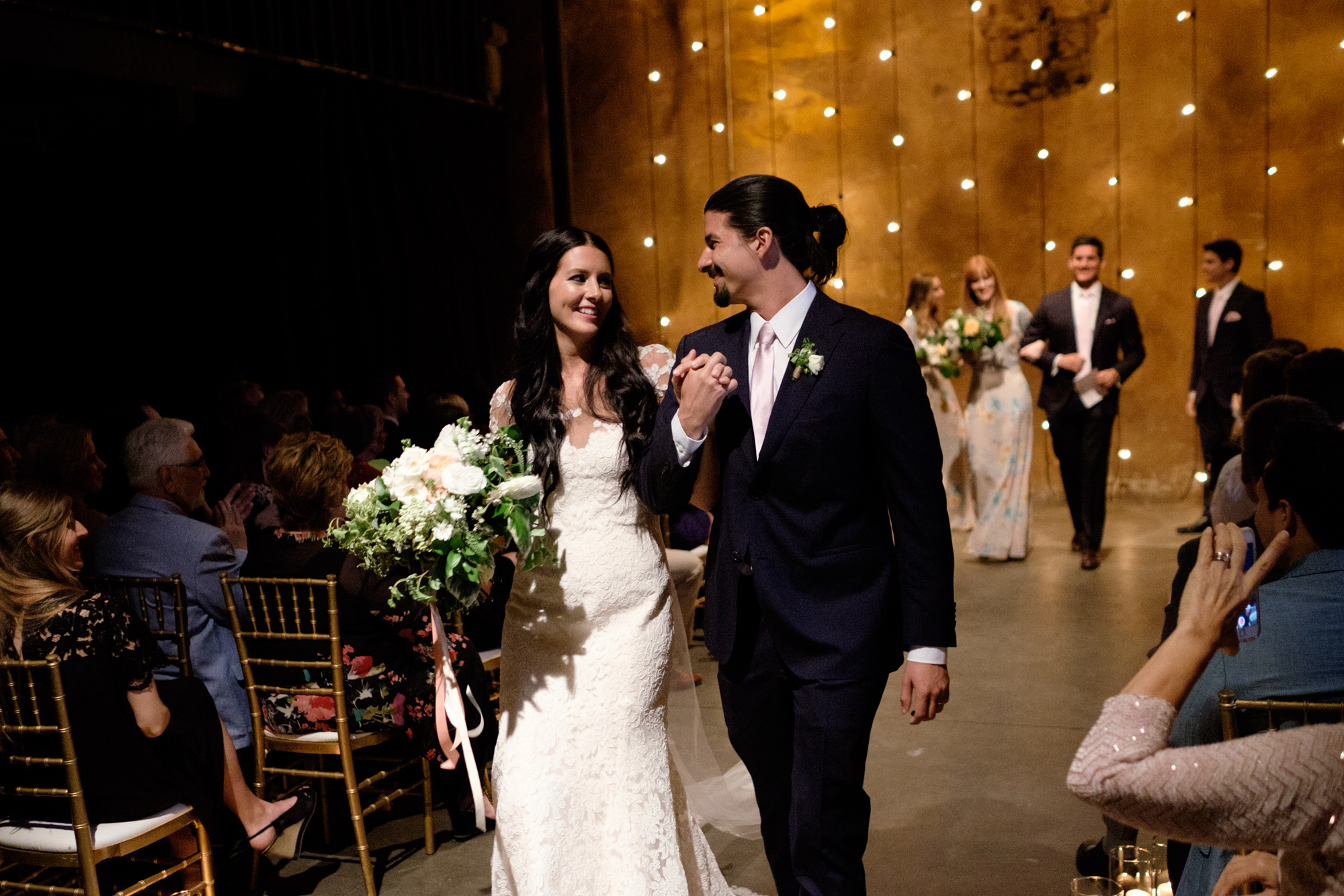 Danni + Felipe walk back down the aisle after their wedding ceremony at Toronto's Fermenting Cellar.