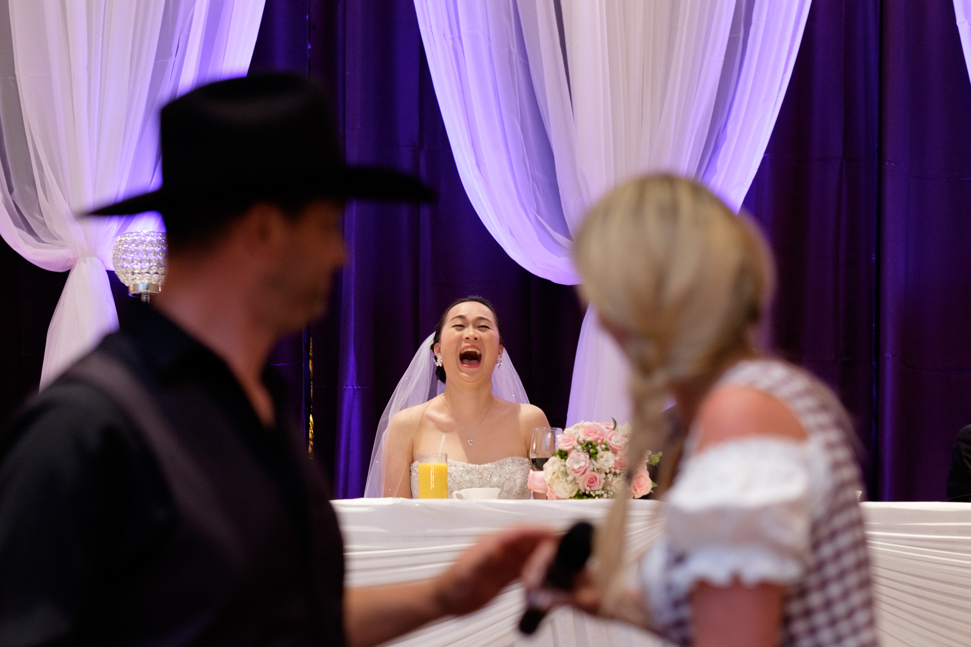 Rene's sisters and brother in toast the bride during Jing + Rene's wedding reception at the Premiere Ballroom.