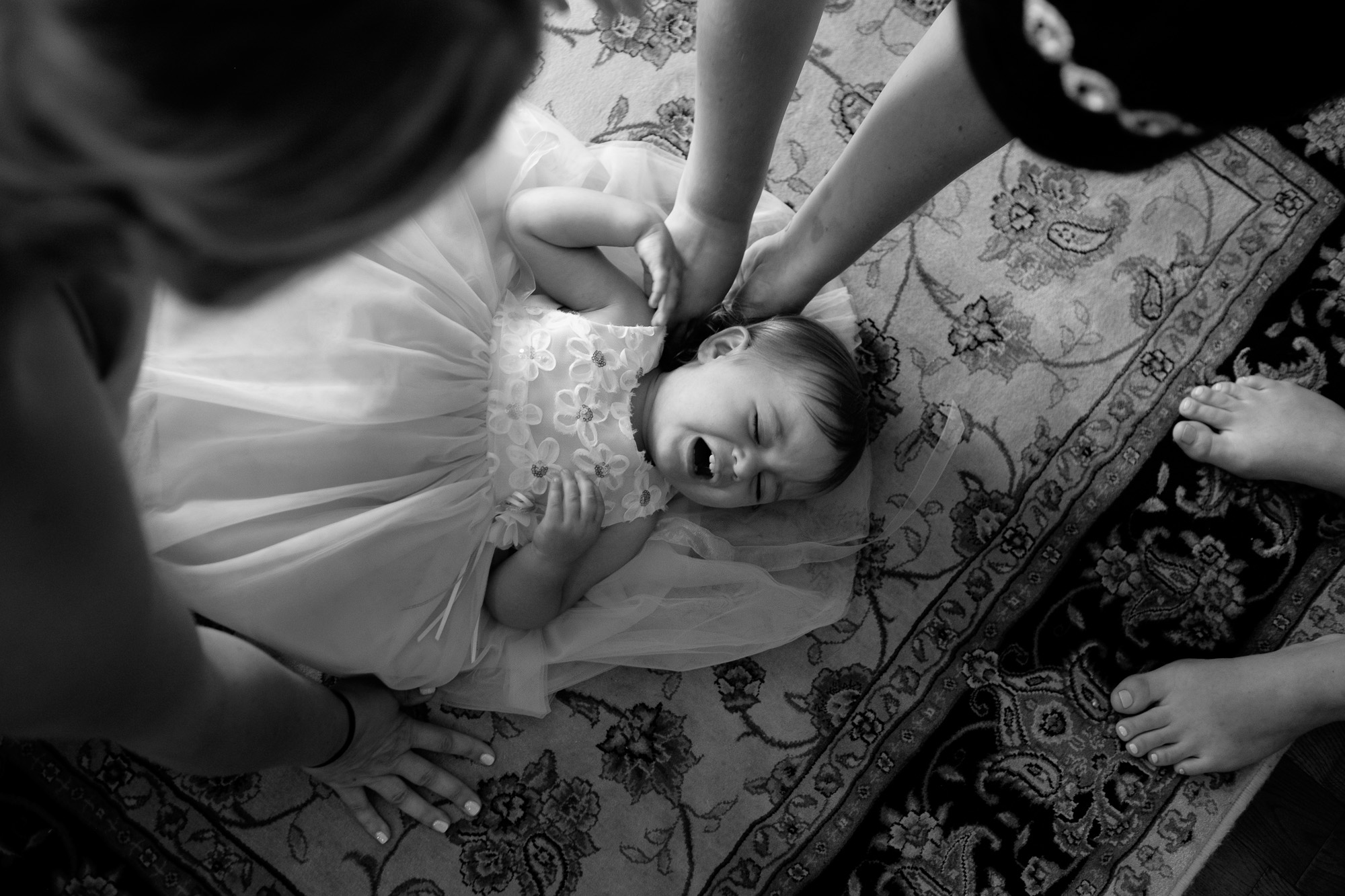 The flower girl objects to wearing her dress before Melanie & David's wedding in Toronto.
