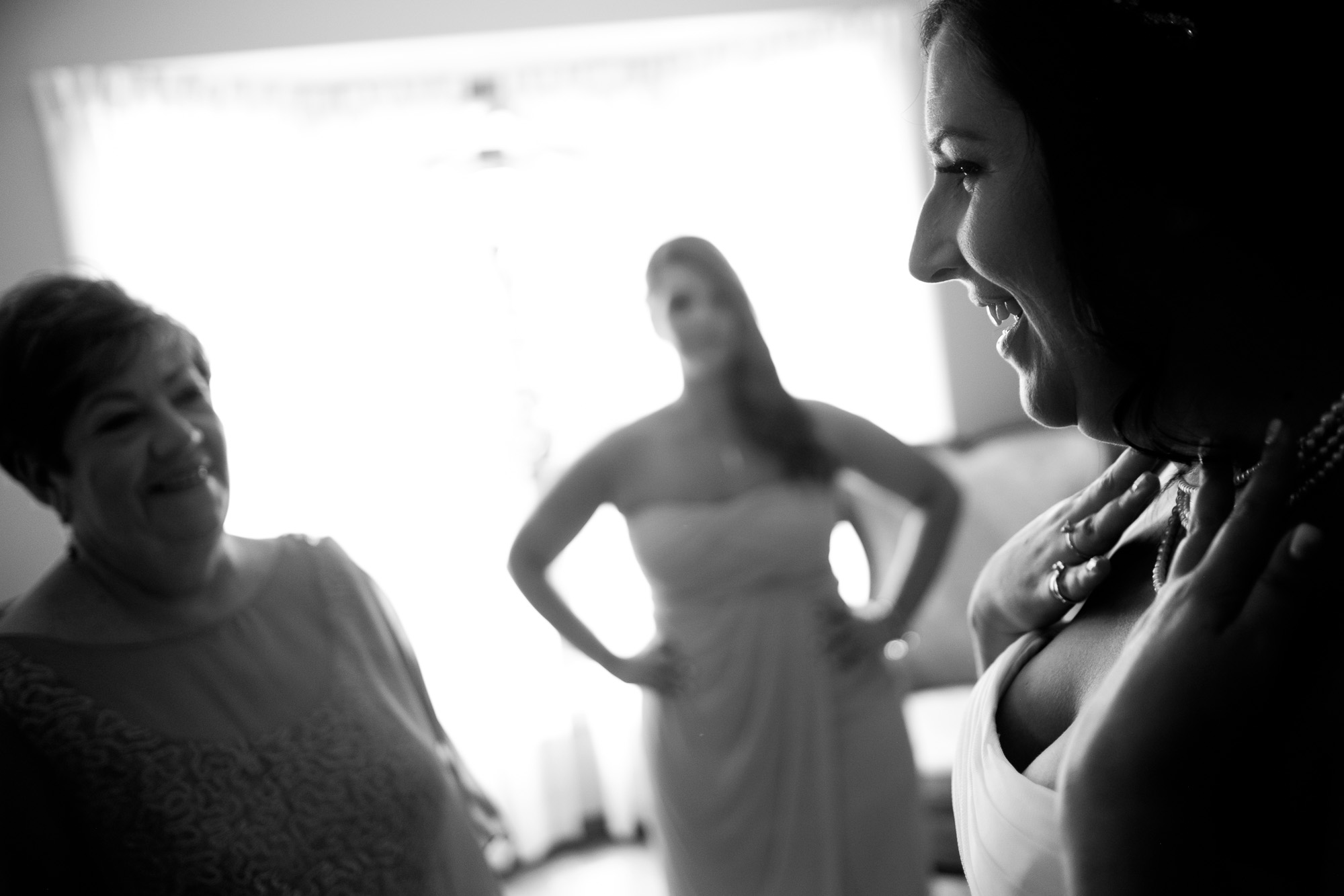  Melanie's mom looks on as she puts the finishing touches on her wedding dress and jewelry before her wedding in Toronto.&nbsp; 