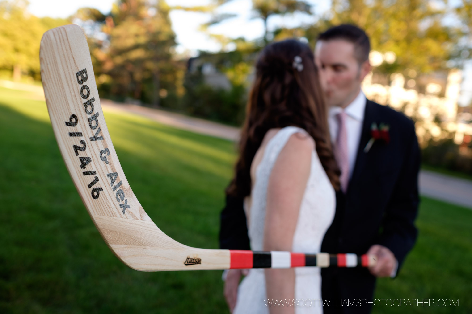  A wedding portrait of a couple posing with a custom hockey stick in front of Langdon Hall in Cambridge, Ontario.&nbsp; 