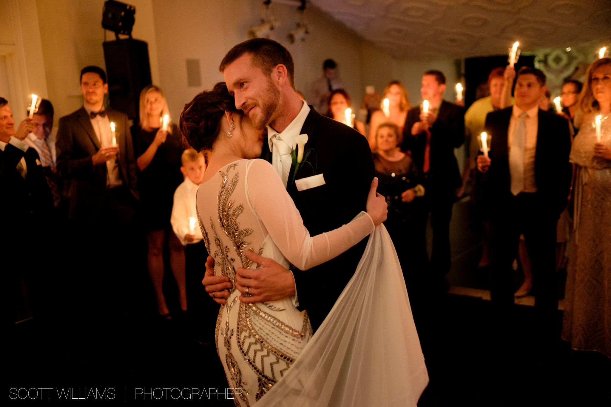 Christina + Tim are surrounded by their wedding guests with lit candles as they enjoy their first dance as a newly married couple at Malaparte in Toronto. 