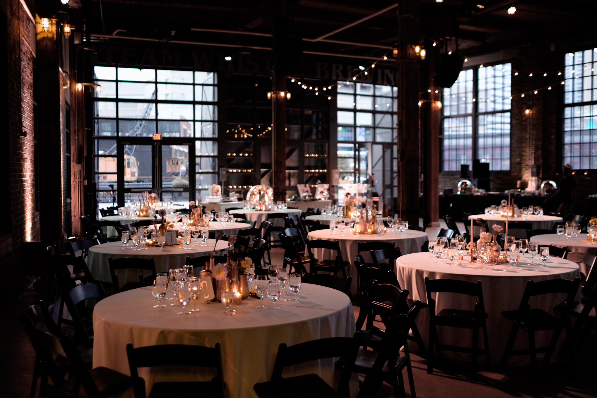 A wedding detail photograph of the reception room at Savannah + Bernie's wedding at the SteamWhistle Brewery in Toronto. 