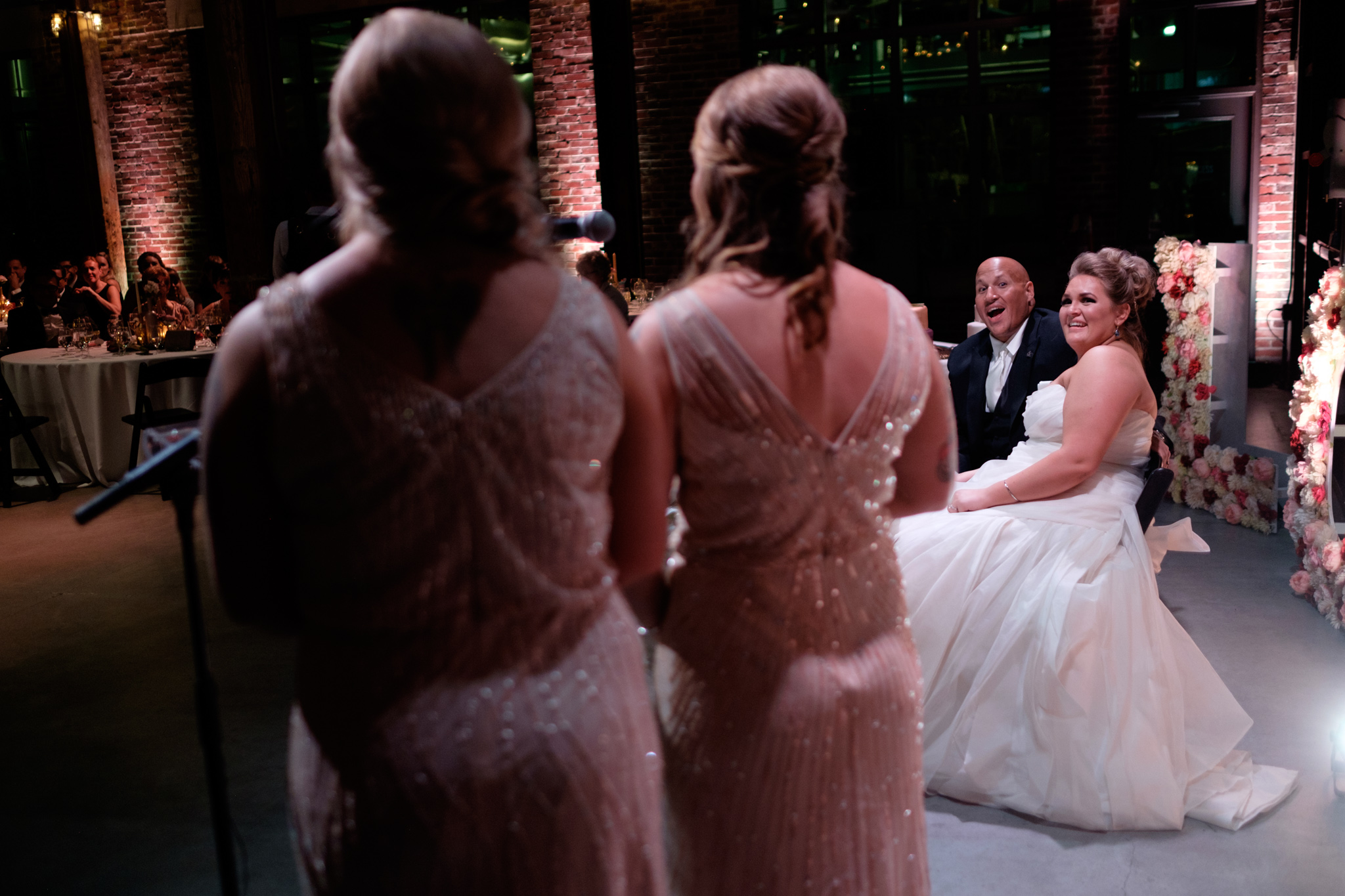 Savannah and Bernie share a laugh as Savannah's sisters give their speech during the reception at their SteamWhistle Brewery wedding in Toronto. 