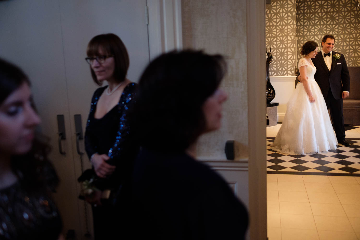 a newlywed couple wait for their guests to arrive for the wedding reception at Graydon Hall in Toronto. 