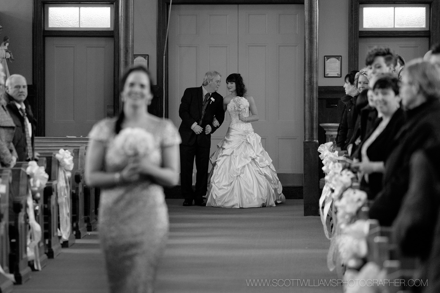 The bride and her father share a moment before walking down the aisle during her wedding in North Bay, Ontario. 
