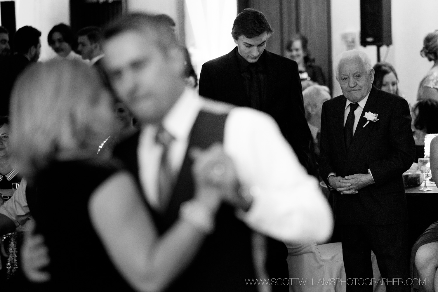  The grooms father looks on as David dances with his sister during their wedding reception in North Bay, Ontario.&nbsp; 