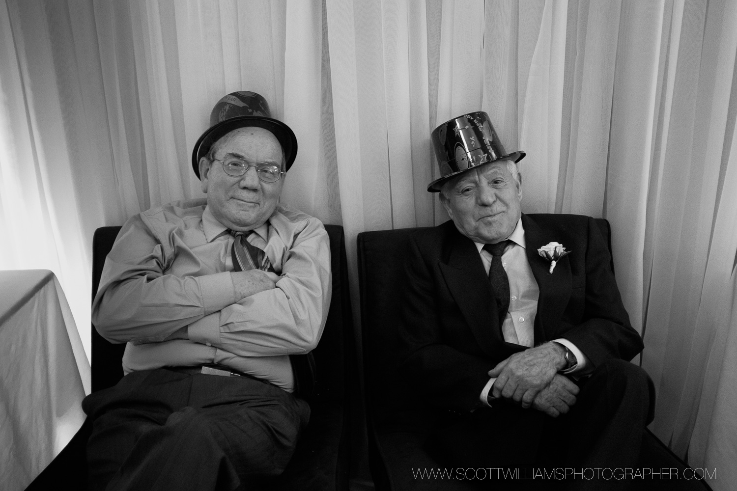  Two guys enjoying a quiet corner during the wedding reception in North Bay, Ontario.&nbsp; 