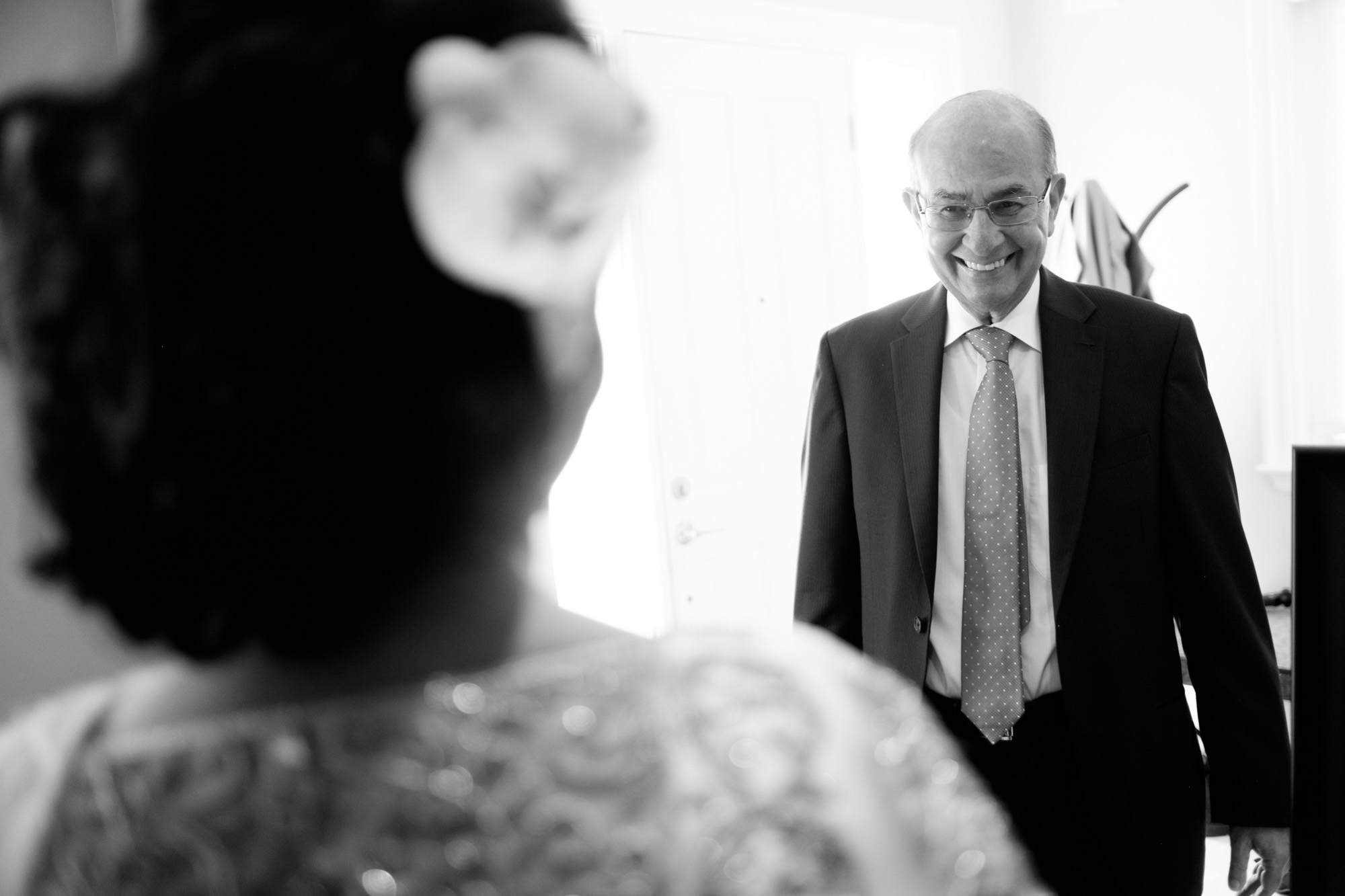 The bride Noor's father smiles as he sees his daughter for the first time before their wedding ceremony at the Toronto Reference Library.