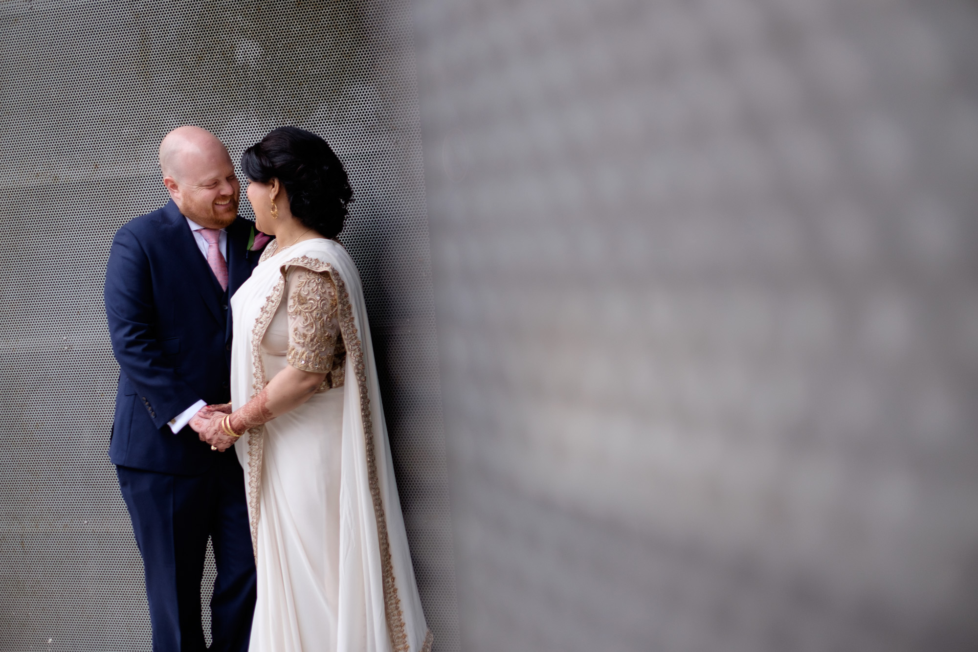 Noor and John pose for a wedding portrait on the streets of Toronto before their wedding ceremony at the Toronto Reference Library.