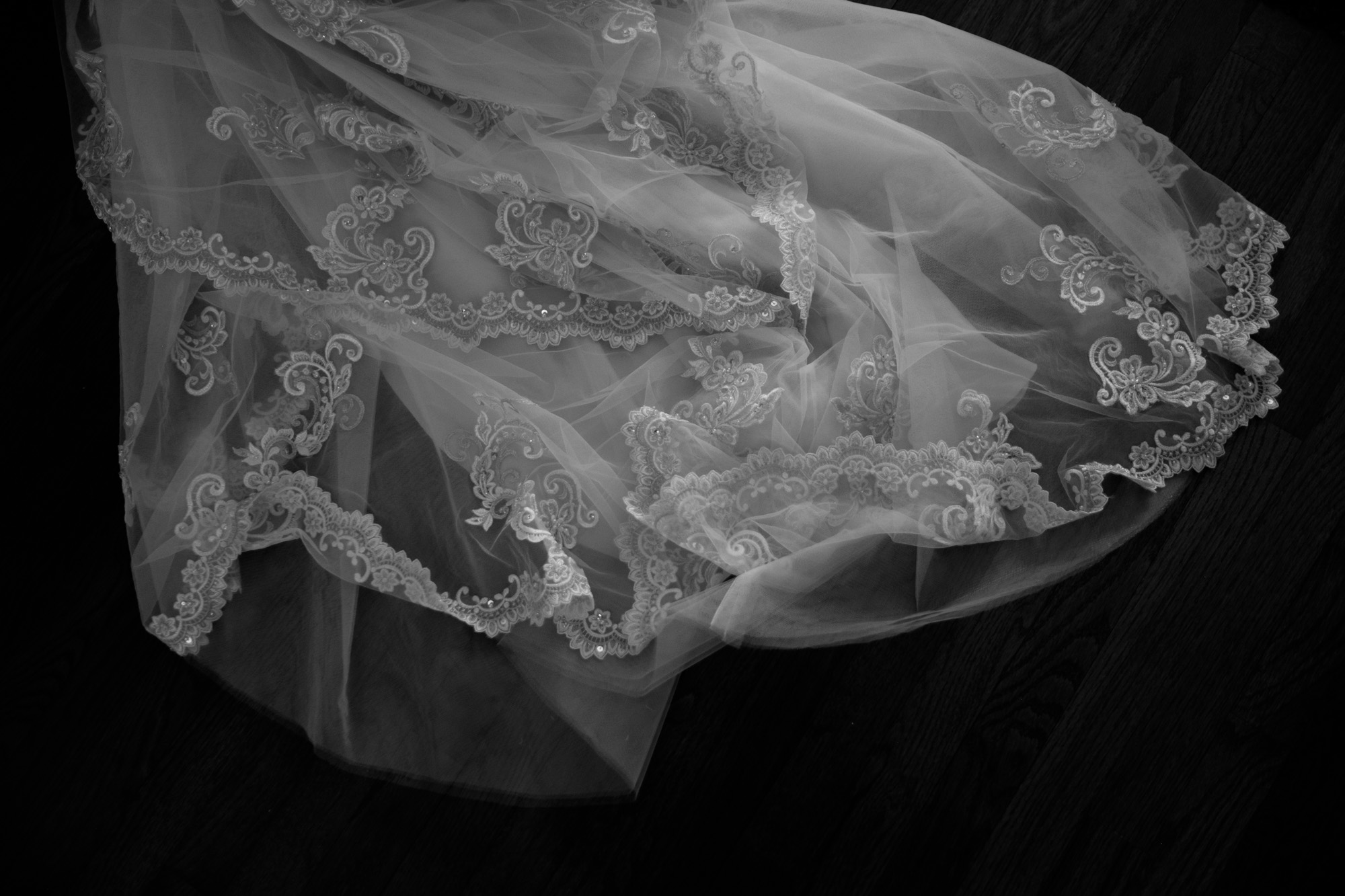 A black and white detail photograph of the brides wedding dress before the ceremony at Whistle Bear in Cambridge. 