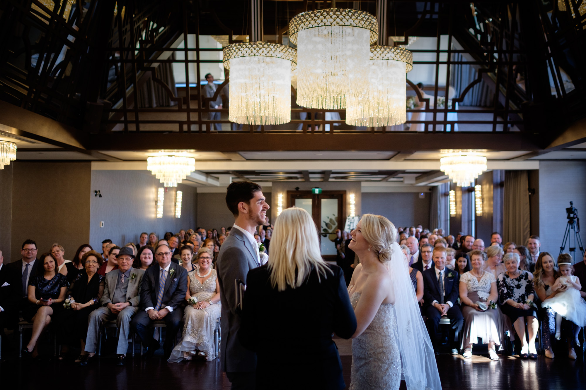 Sarah + Rob share a laugh during their wedding ceremony at Whistle Bear in Cambridge, Ontario. 