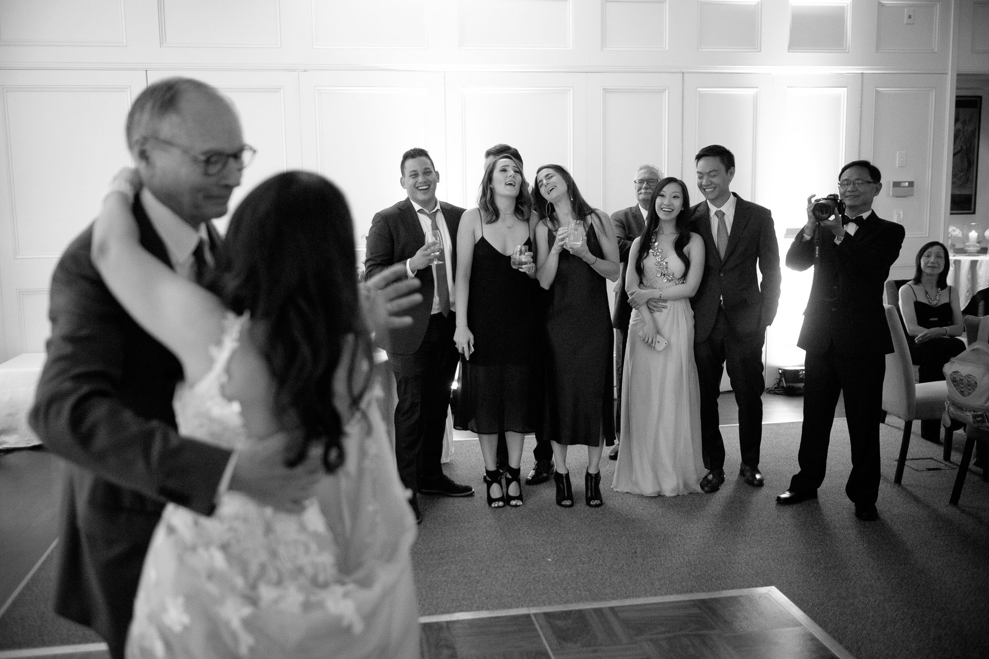 Friends and family look (and sing) along as Teresa + Robert enjoy their first dance as a newly married couple during their wedding reception at Langdon Hall in Cambridge, Ontario.