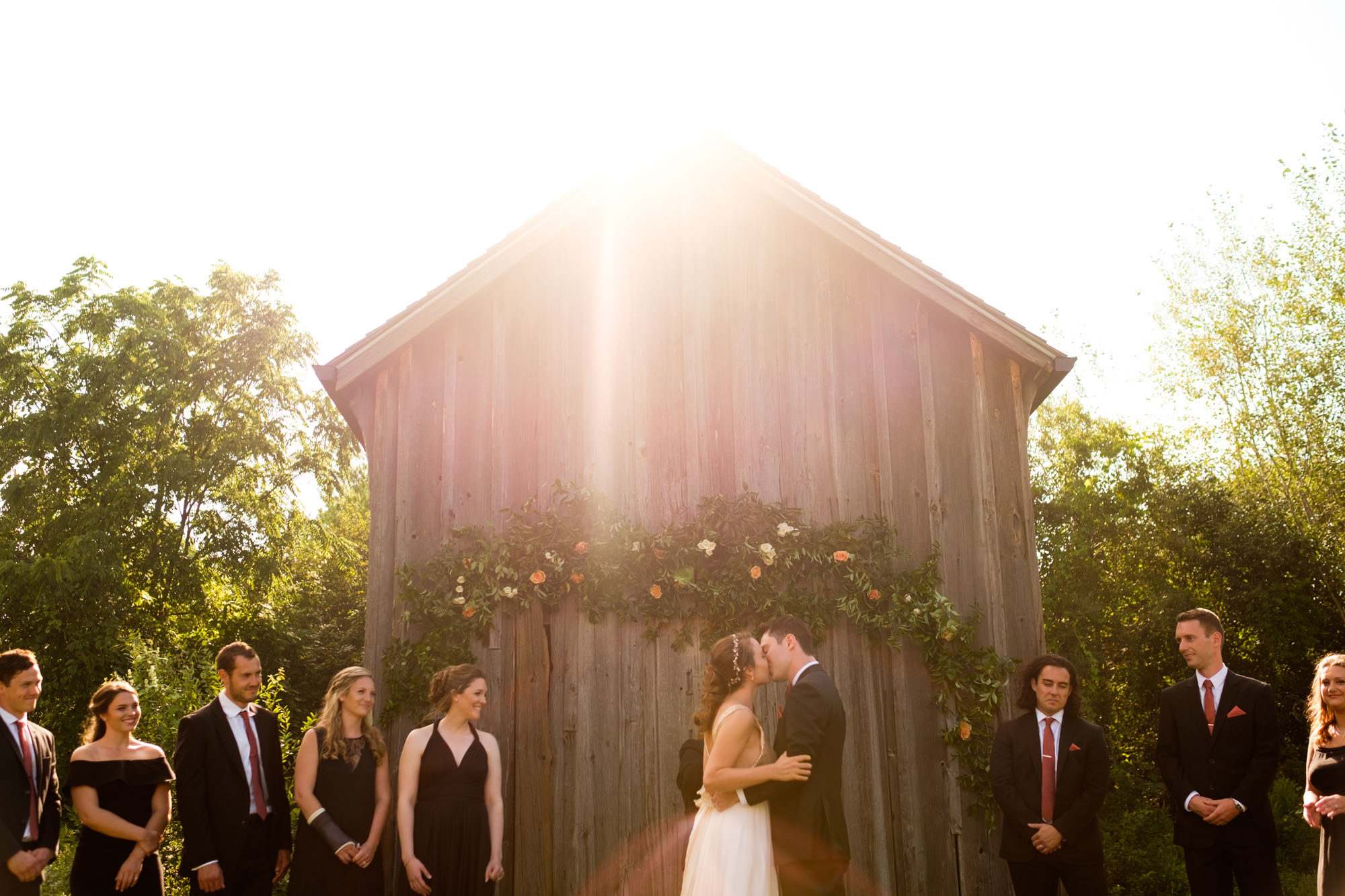 Jennifer and Andrew kiss during the outdoor wedding ceremony at the Markham Museum 