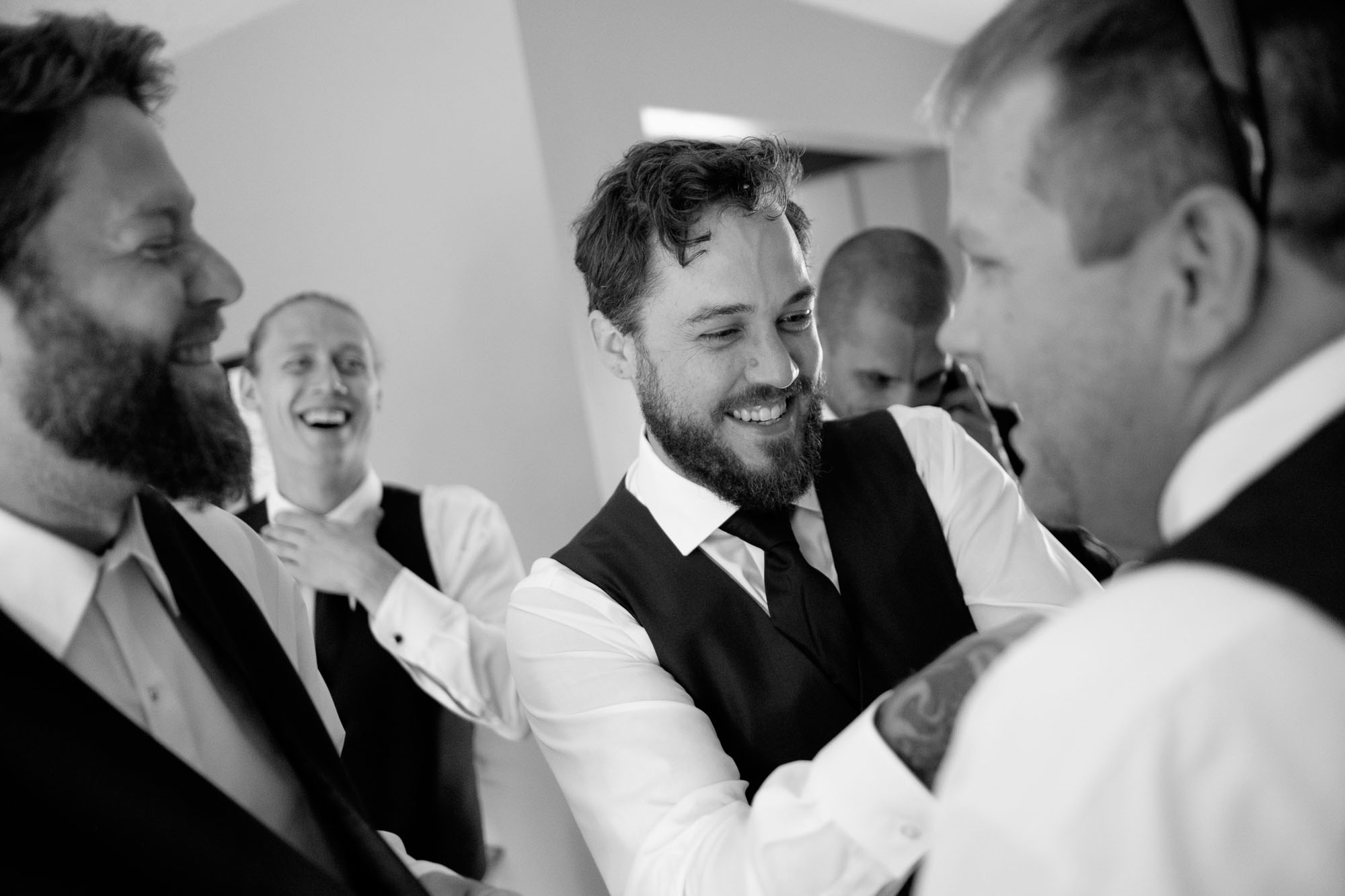 Adam adjusts the tie on one of his groomsmen as they all get ready for his backyard wedding in Ontario, Canada. By Scott Williams.